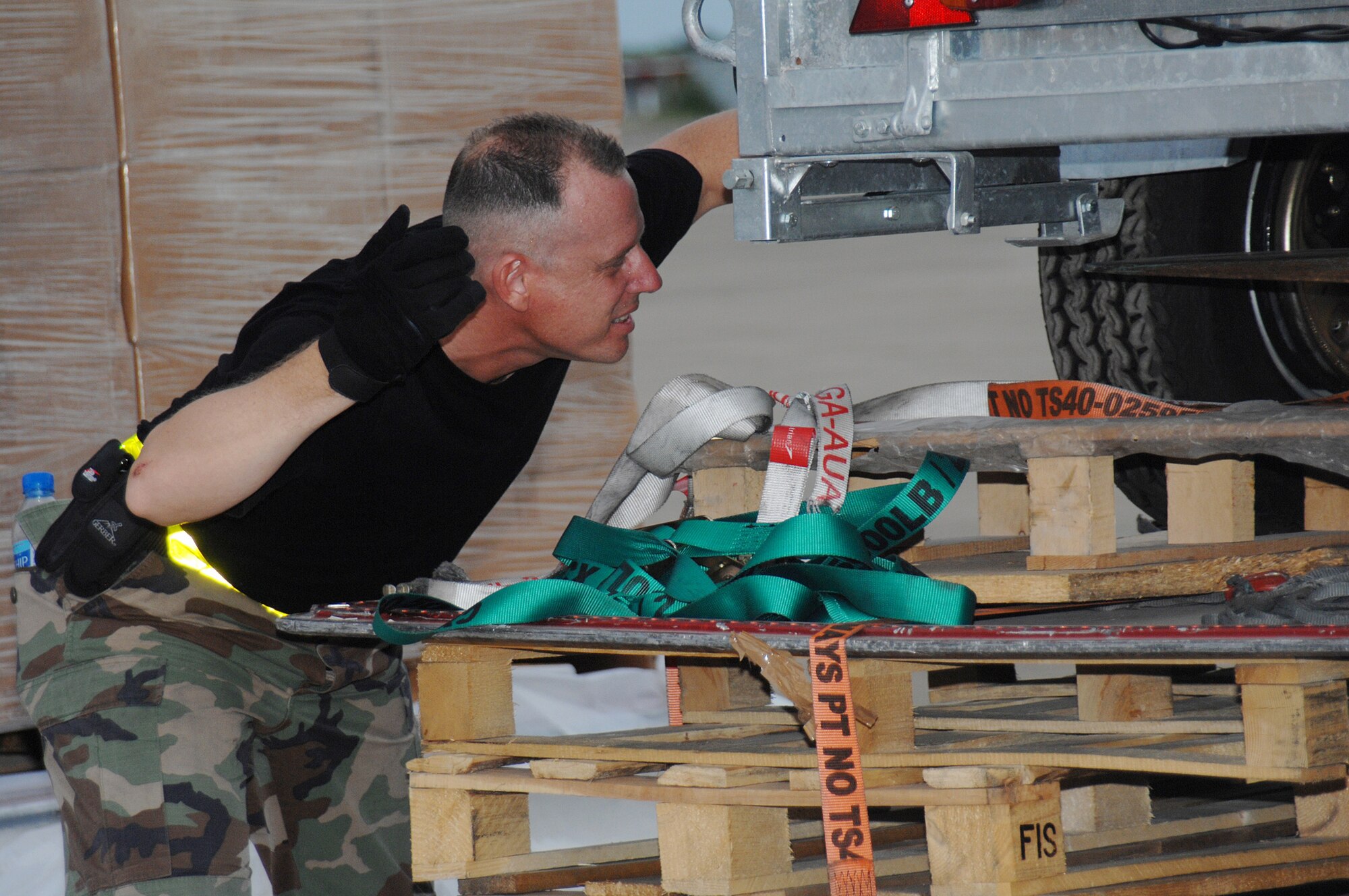 Utapao, Thailand - Technical Sgt John Kortez, 36th Contingency Response Squadron from Andersen AFB, Guam directs the placement of a forklift for the transfer of humanitarian relief supplies being downloaded from a Boeing 747 commercial airplane for delivery into Burma May 16. (USAF photo/Senior Airman Sonya Croston)(RELEASED)