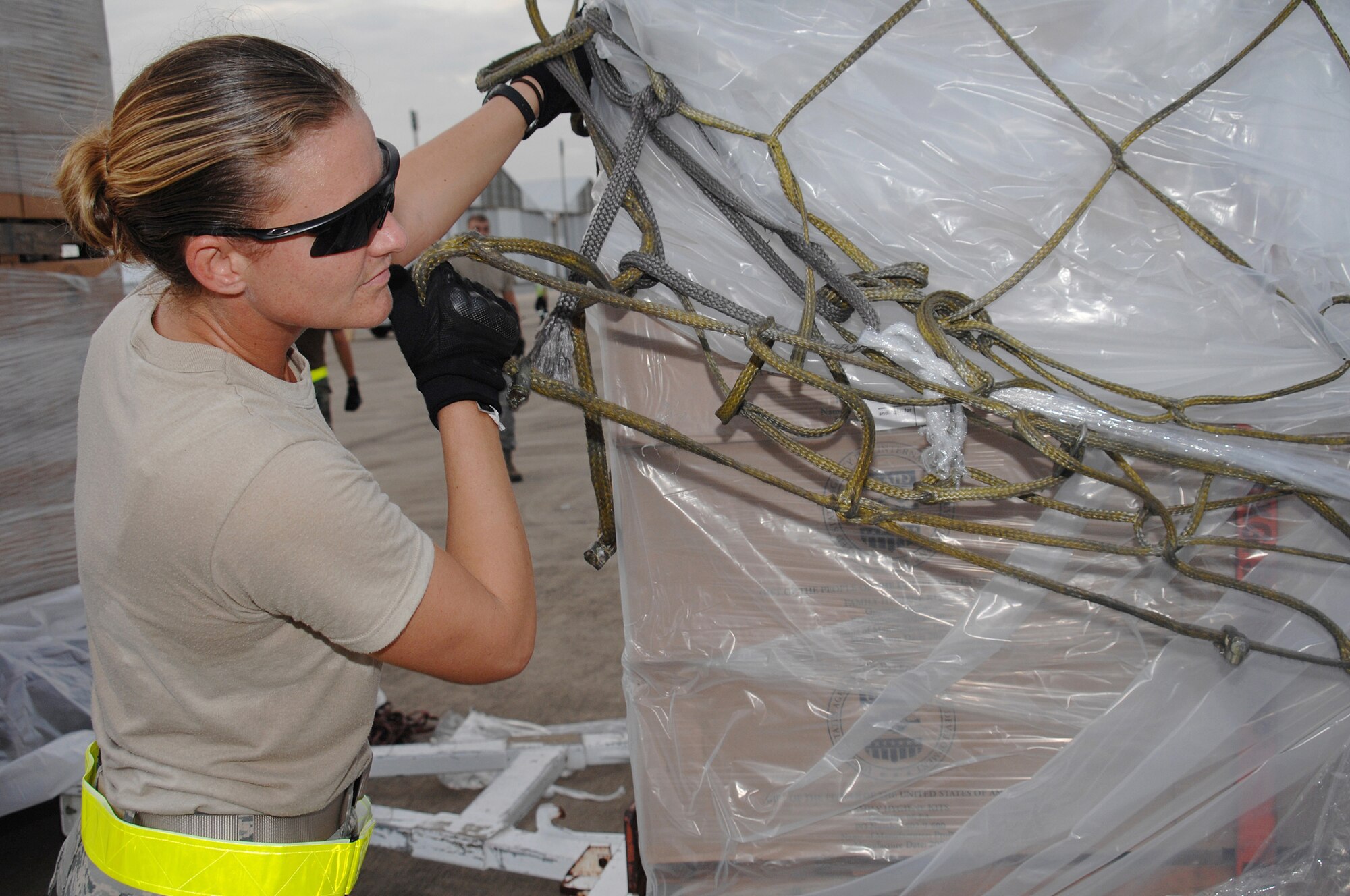 Utapao, Thailand - Staff Sgt Brandi Burns removes cargo netting during the download of humanitarian relief supplies being delivered to Burma May 16. SSgt Burns is forward deployed with the 736th Security Forces Squadron from Andersen AFB, Guam. (USAF photo/Senior Airman Sonya Croston)(RELEASED)