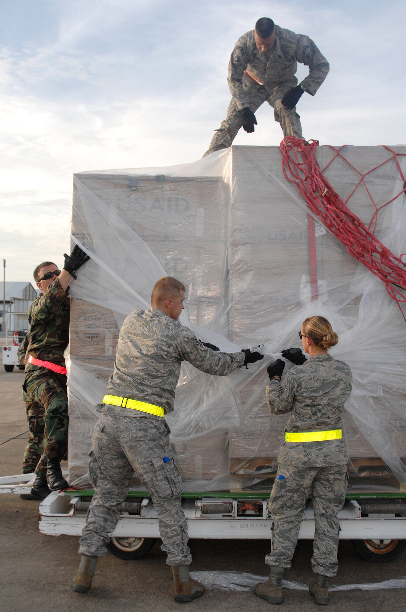 Utapao, Thailand - Airmen from Andersen AFB, Guam download humanitarian relief supplies from a Boeing 747 commercial airplane in preparation for its delivery to Burma May 16. Approximately 45 members forward deployed with the 36th Contingency Response Squadron to provide their assistance with aid and recovery after Cyclone Nargis struck on May 2. (USAF photo/Senior Airman Sonya Croston)(RELEASED)