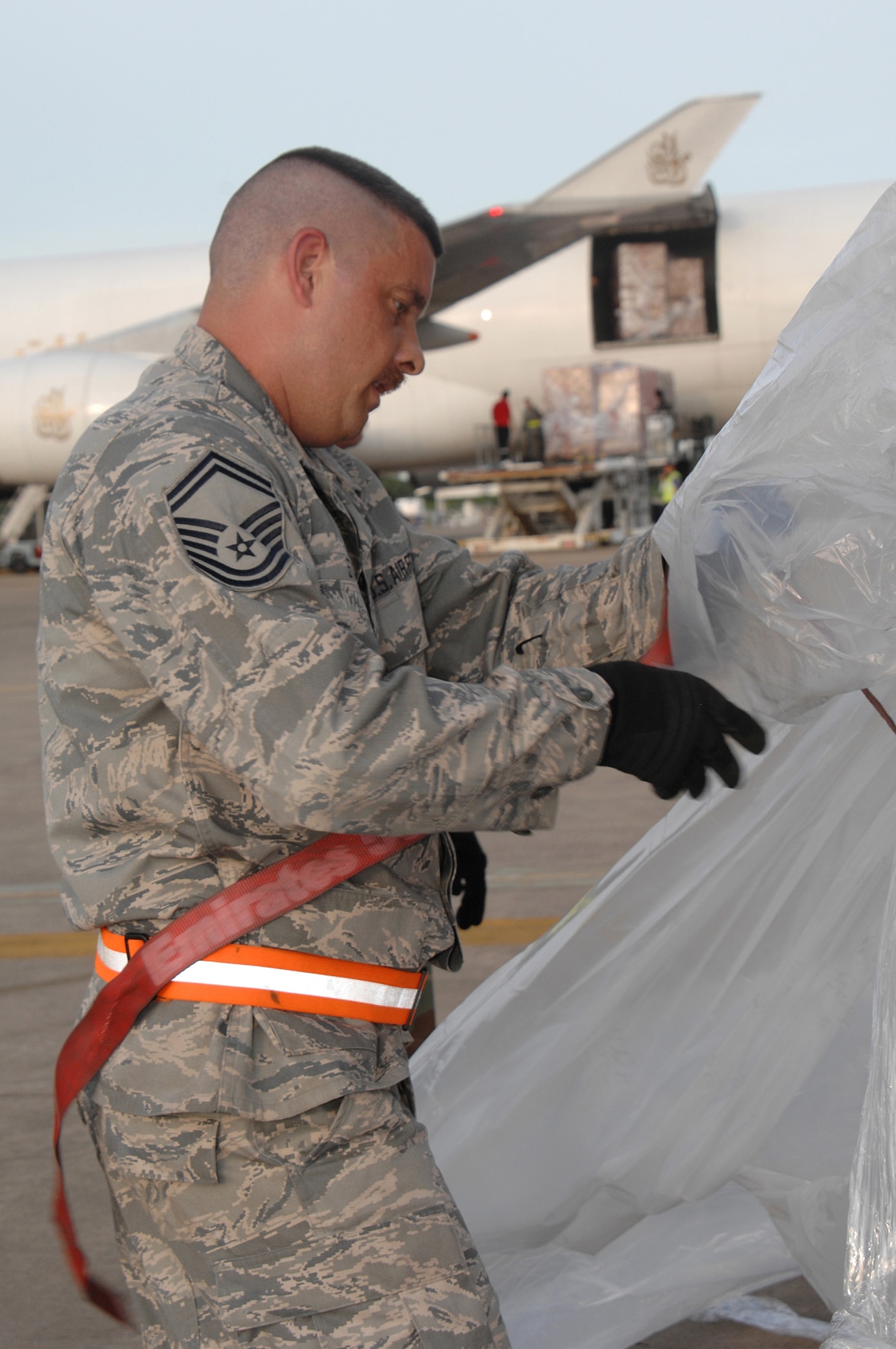 Utapao, Thailand - Senior Master Sgt Gregory Stone, removes plastic lining from a pallet of relief supplies being delivered from Utapao Thai Royal Navy Air Base, Thailand to Burma May 16. SMSgt Stone is forward deployed with the 36th Contingency Response Group from Andersen AFB, Guam. (USAF photo/Senior Airman Sonya Croston)(RELEASED)