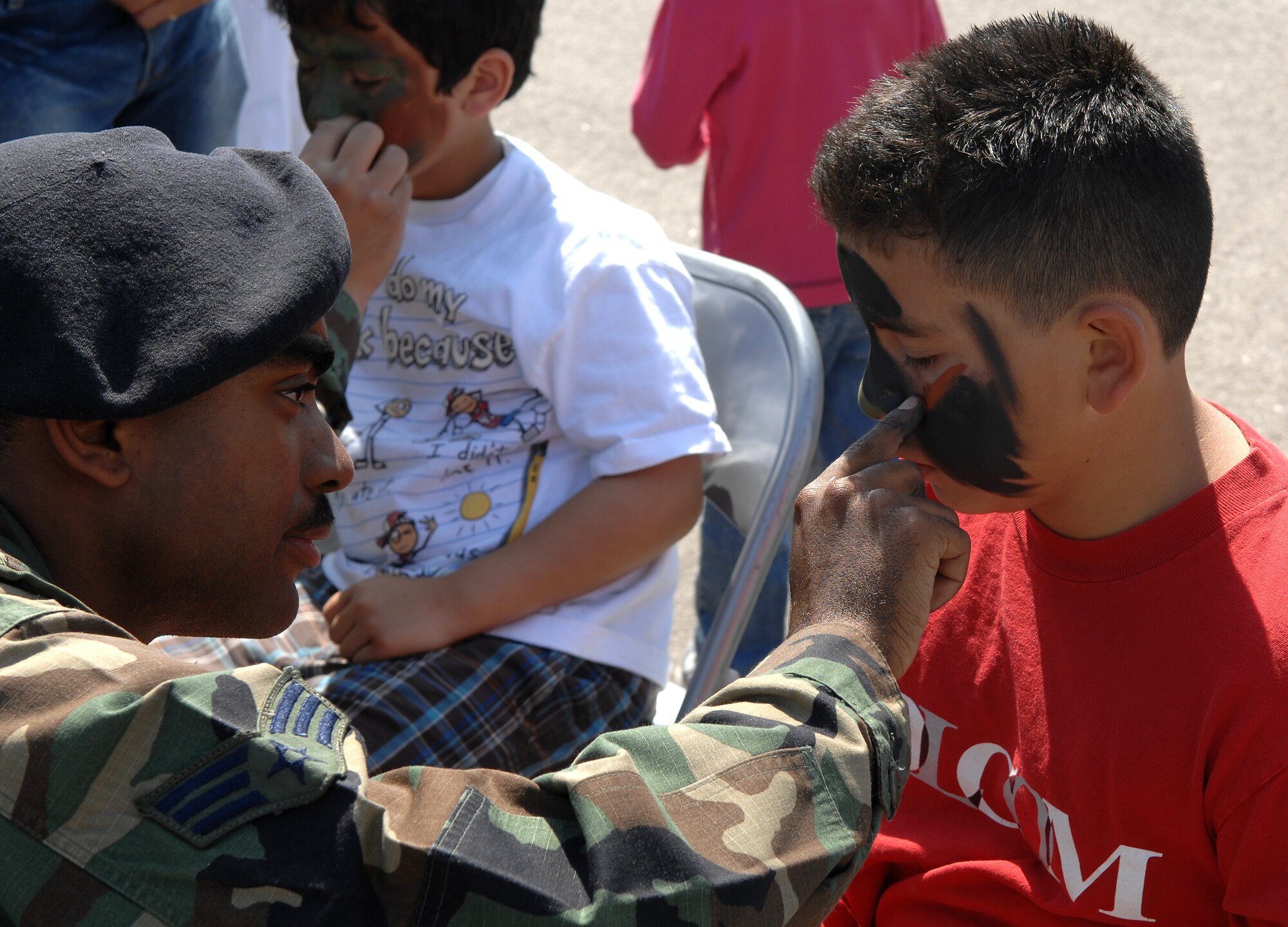 Senior Airman Eric Rosburough from the 452 Security Forces Squadron applies face paint to Jose, eight, from Lake Forrest.  AirFest '08 featured both military and civilian aerial and ground demonstrations during the two day air show, May 3-4, 2008 at March Air Reserve Base, Riverside, California. (U.S. Air Force photo by SrA Matthew Smith)