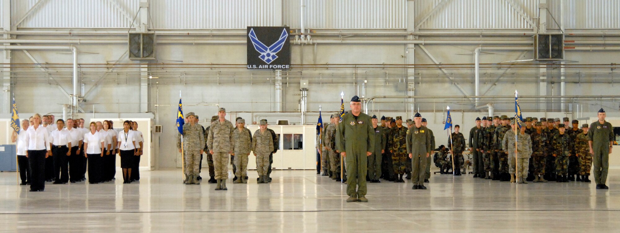 People of the 412th Test Wing stand at attention during the wing's change of command ceremony at hangar 1600 here May 19. As the 412th TW commander, Col. William Thornton, is responsible for the air frame, power plant, avionics, and electronic warfare development, test, evaluation of manned and unmanned aerospace systems, to include the operations of all Edwards test facilities and ranges and the U.S. Air Force Test Pilot School. (Air Force photo by Senior Airman Stacy Sanchez) 
