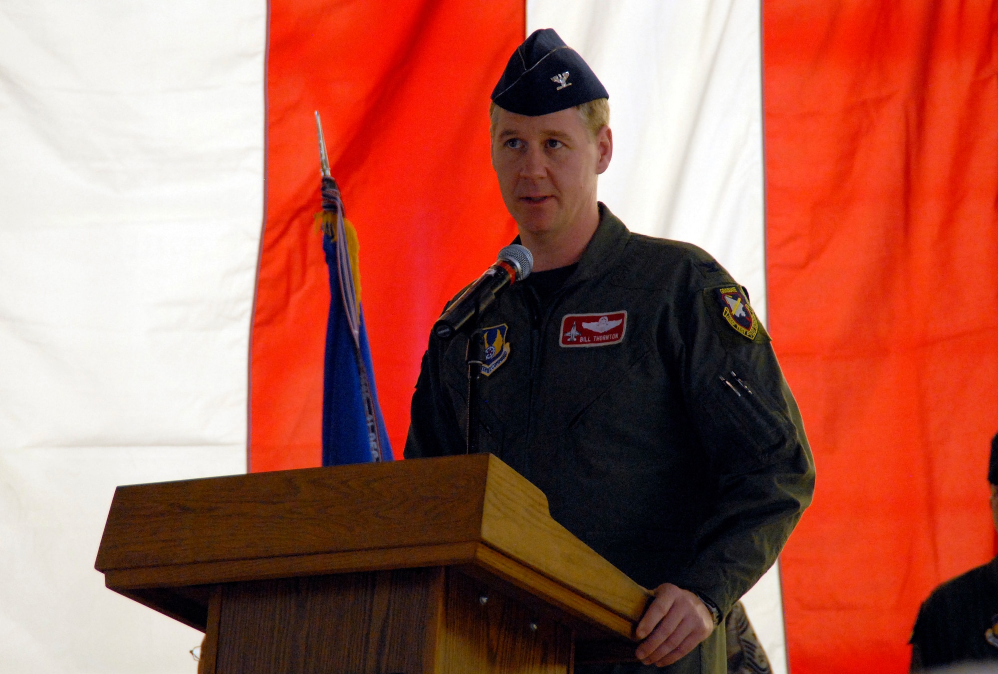 Col. William Thornton, 412th Test Wing commander, talks to the crowd during his change of command ceremony at hangar 1600 here May 19. Colonel Thornton succeeds Col. Arnold Bunch, who will become the vice commander of the Air Armament Center at Eglin Air Force Base, Fla. (Air Force photo by Senior Airman Stacy Sanchez)