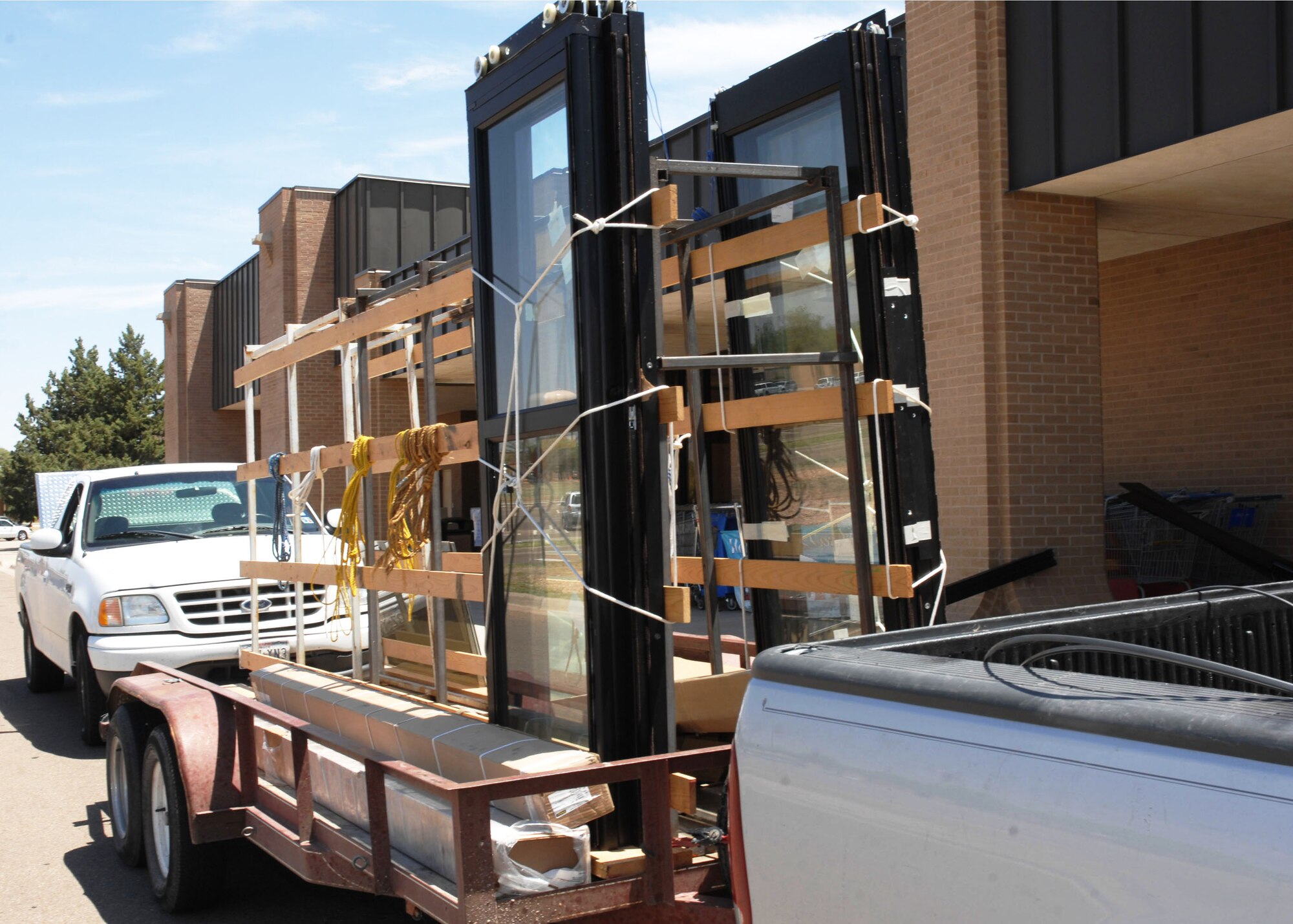 CANNON AIR FORCE BASE, N.M.-- New sliding exit doors arrive at the commisary on May 12 and await installation. The doors were just part of an overall upgrade made to the facility that included new shelving and plumbing. (U.S. Air Force photo by Airman Maynelinne De La Cruz)
