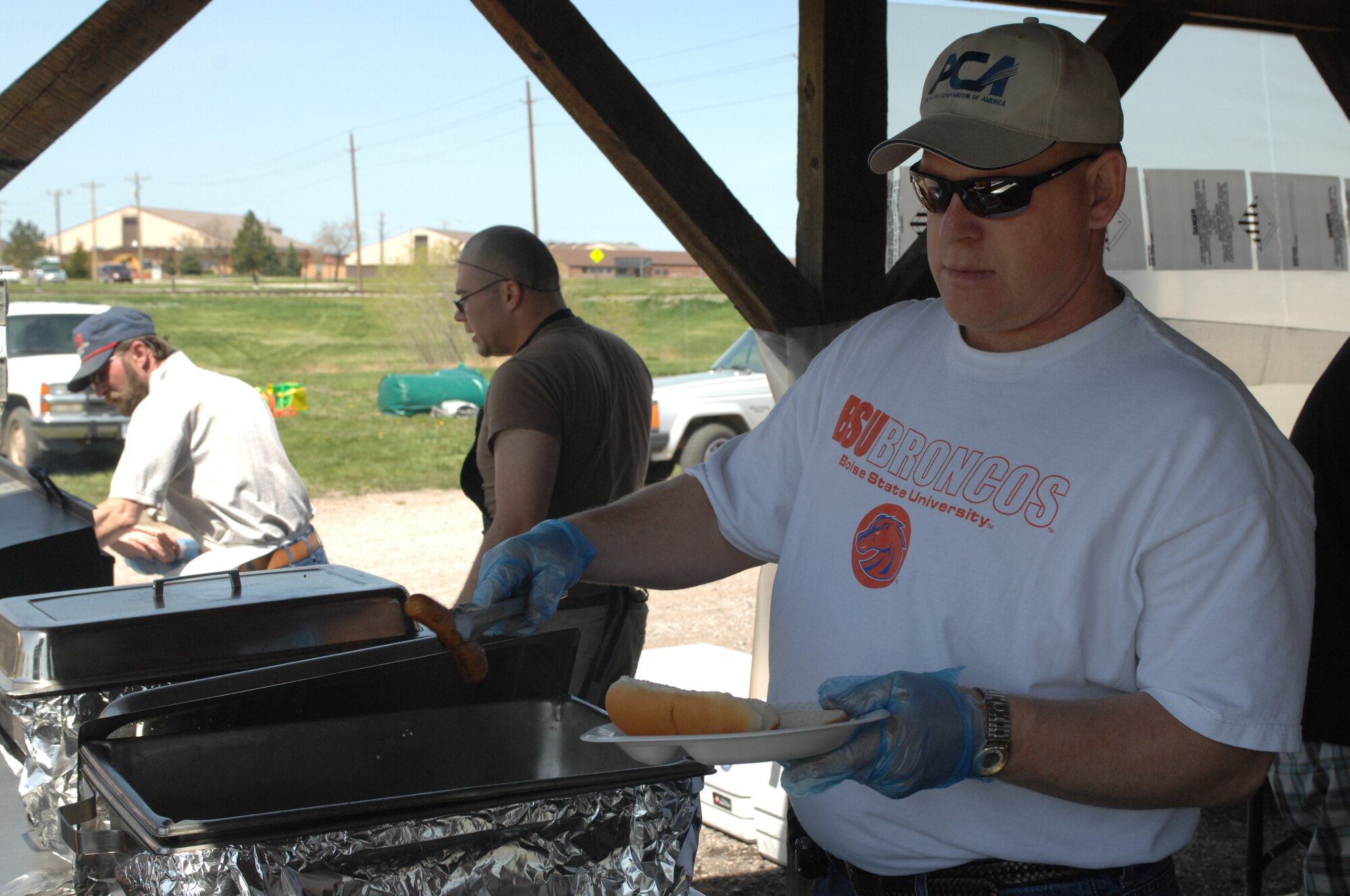Chief Master Sgt. Rick Ives, 28th Mission Support Group chief enlisted manager, serves Airman and their families during the Party at the Lake on base, May 17. The Party at the Lake was a free picnic hosted by the Ellsworth Outdoor Recreation Center, Ellsworth Airman and Family Readiness Center and the Black Hills Center. (U.S. Air Force photo/Airman 1st Class Joshua Seybert) (Released)
