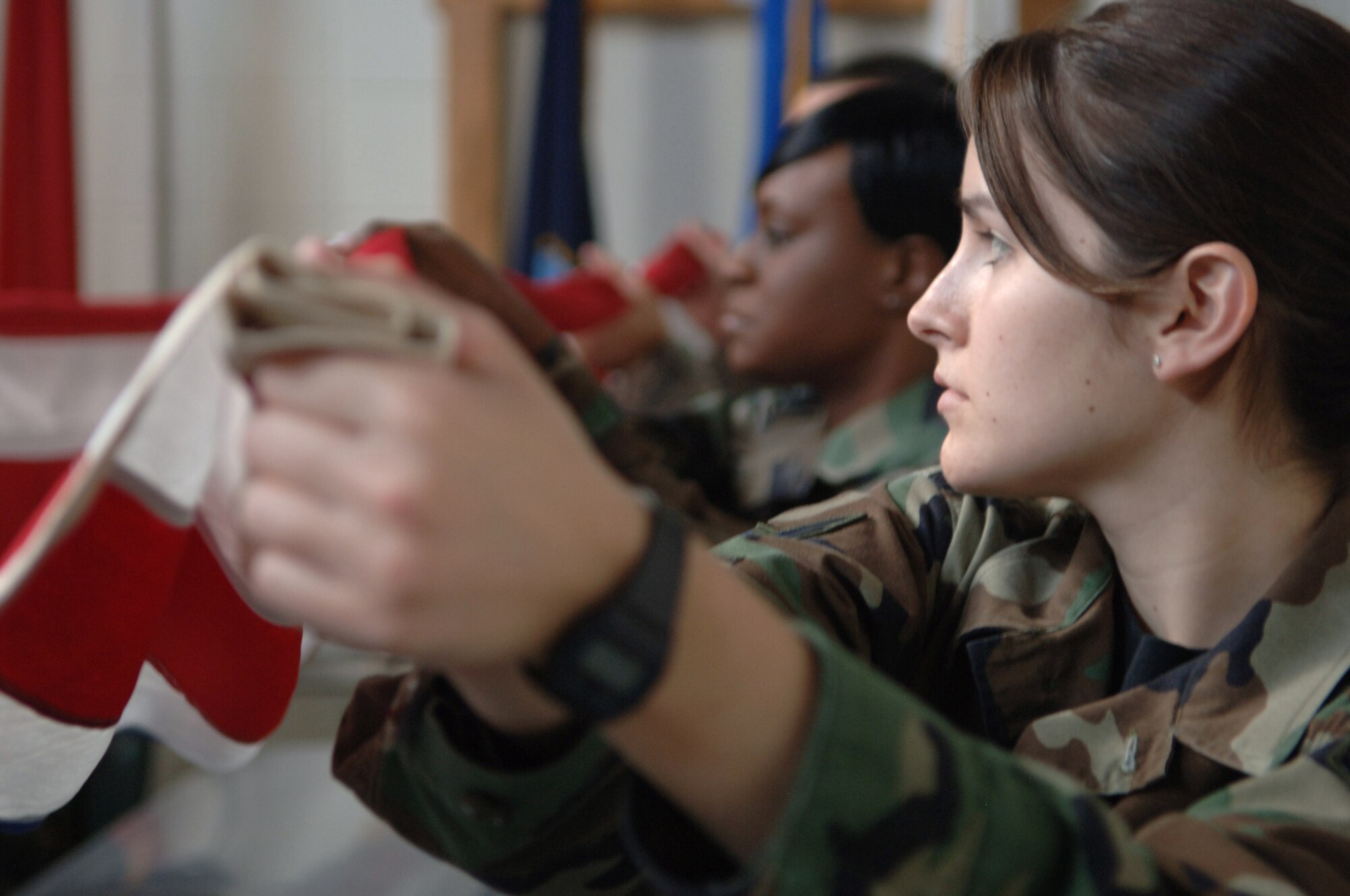 Airman 1st Class Andrea Gustin, 28th Medical Operation Squadron mental health technician, learns proper flag-folding techniques during honor guard practice, May 15.  Honor Guard members practice weekly to ensure proper honors are executed in all ceremonies.  (U.S. Air Force photo/Airman Corey Hook)(Released)