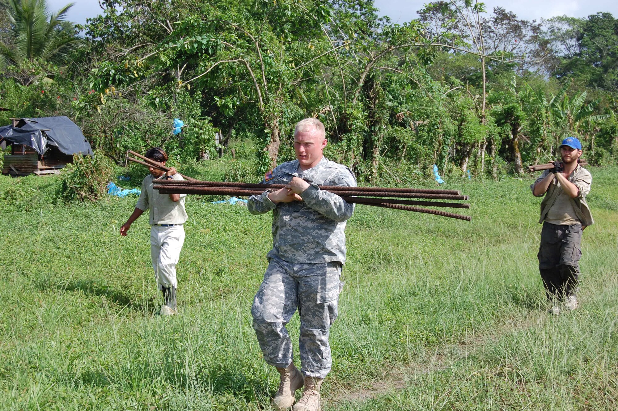 Sgt. Aaron Burrows, Joint Task Force-Bravo flight medic, and volunteers haul rebar to aircraft waiting to haul the bridge building materials to remote sites in Costa Rica. JTF-Bravo crews airlifted 184,000 pounds of payload during 38 lifts May 9-14. 
