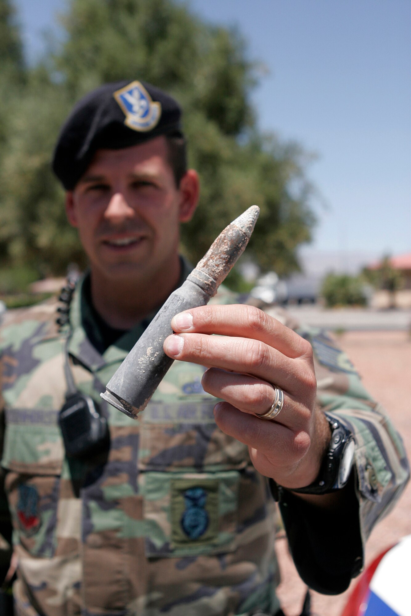 NELLIS AIR FORCE BASE, Nev.—Staff Sgt. Robert Eichenhorst, 99th Security Forces Squadron patrolman, examines unexploded ordnance found on a construction site while on patrol here May 13. Nellis patrolmen are prepared to work closely with various organizations on base, in this case Explosive Ordnance Disposal, to keep everyone safe. (U.S. Air Force photo/Staff Sgt. Jacob R. McCarthy)