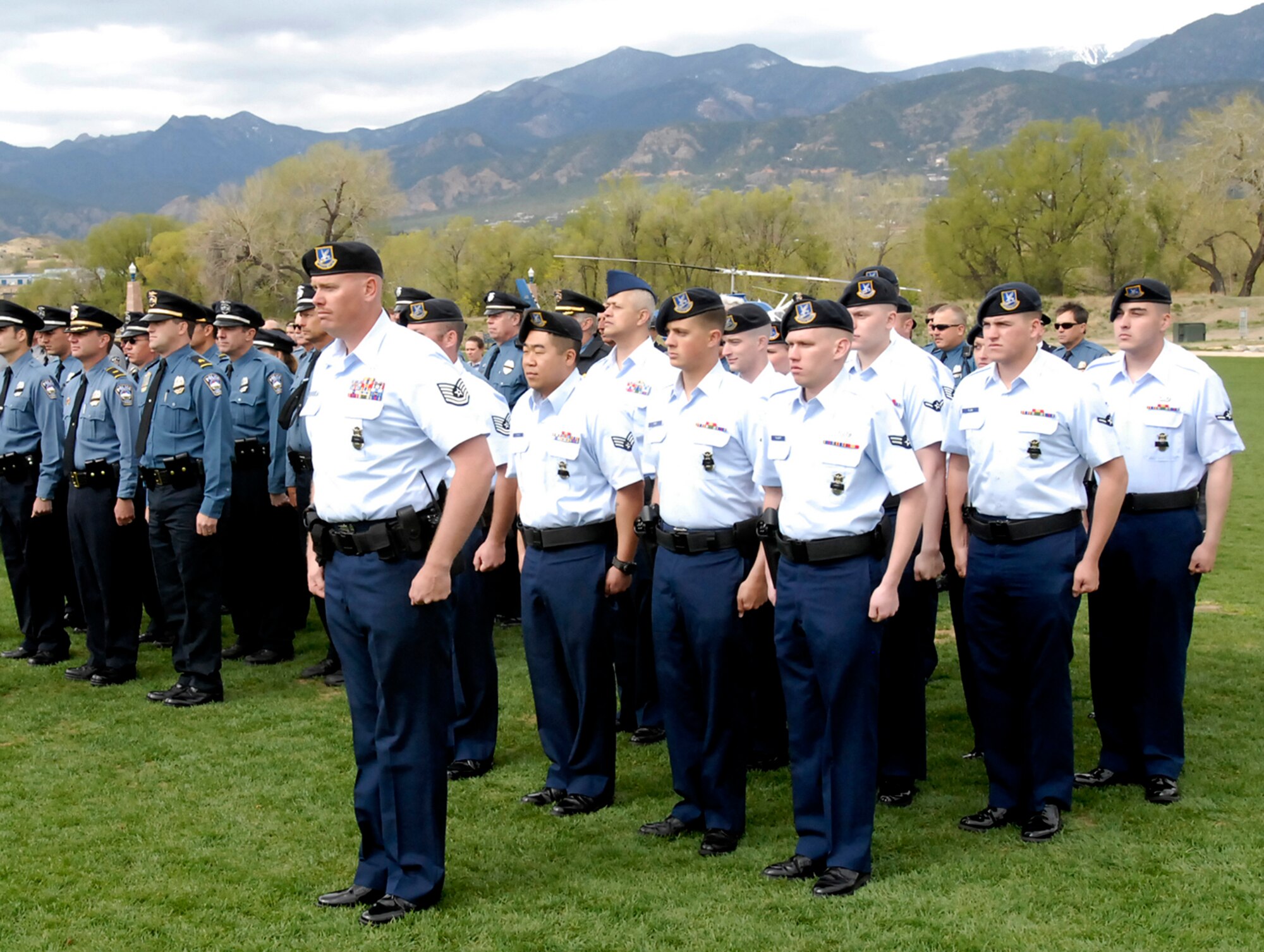 Representatives from the 21st and 721st Security Forces Squadron stand in formation during the 15th Annual Pikes Peak Region Peace Officer Memorial Day Service May 16 at America the Beautiful Park. Members of the 21st and 721st SFS were present to honor fellow peace officers who gave their lives while serving their communities. (U.S. Air Force photo/Robb Lingley)