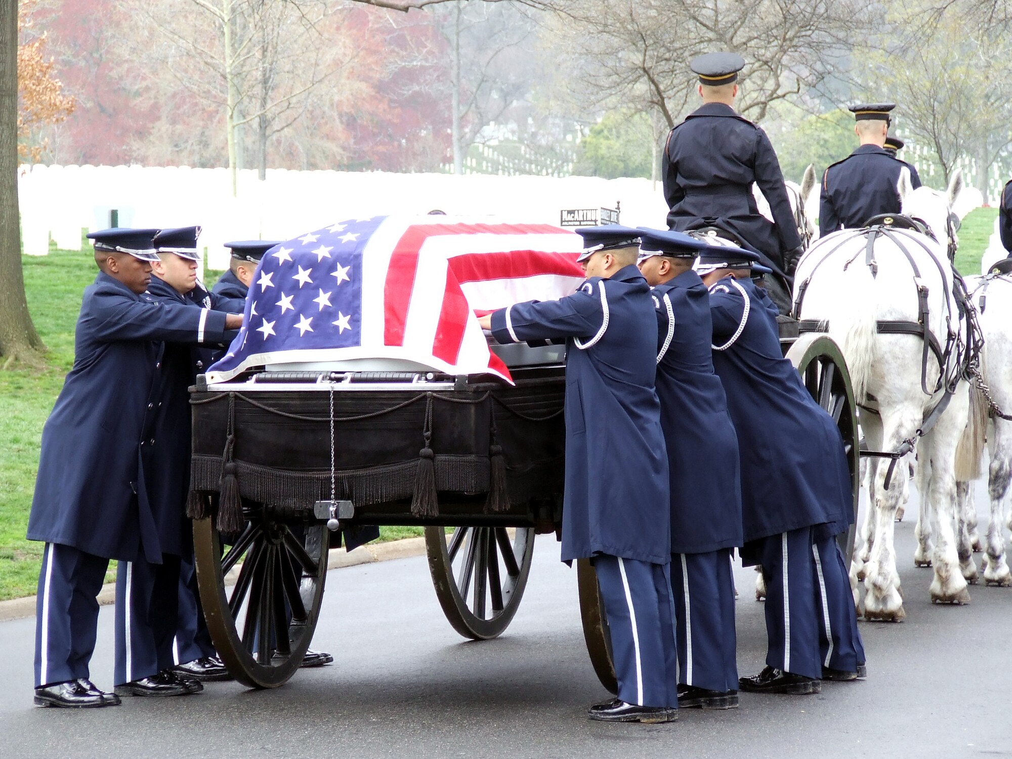 Airmen from the U.S. Air Force Honor Guard prepare to move the flag-draped casket carrying former missing in action Maj. Robert F. Woods from the horse-drawn caisson during the funeral for Major Woods at Arlington National Cemetery, Va., April 9, 2008.  Major Woods was laid to rest nearly 40 years after he disappeared in Vietnam on June 26, 1968.  (U.S. Air Force Photo/Tech. Sgt. Scott T. Sturkol) 