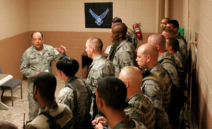 NELLIS AIR FORCE BASE, Nev.—Master Sgt. Carlos Guevara, 99th Security Forces Squadron alpha flight commander, briefs his patrolmen during “guard mount” prior to going out on post here May 13. Speaking with Airmen before each shift lets flight commanders make sure Airmen are physically and mentally ready for duty. (U.S. Air Force photo/Staff Sgt. Jacob R. McCarthy)