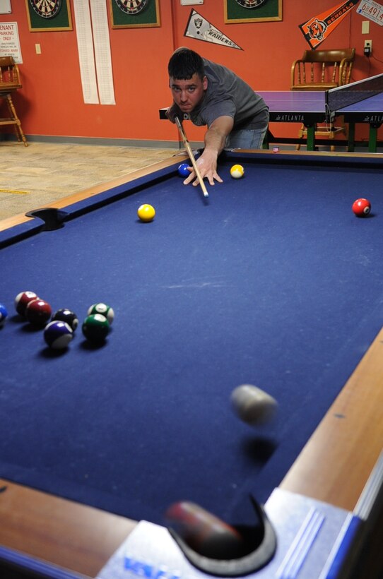 Airman Chris Harris, 28th Bomb Wing, 28th Civil Engineer Squadron heating, ventilation, air conditioning and refrigeration apprentice, Ellsworth Air Force Base, S.D., takes a long shot and pockets the nine ball during the first Airmen Billiards tournament, May 7, 2008.  The tournament began May 7 and will run through June 25; finals begin June 28. (U.S. Air Force photo/Senior Airman Anthony Sanchelli)