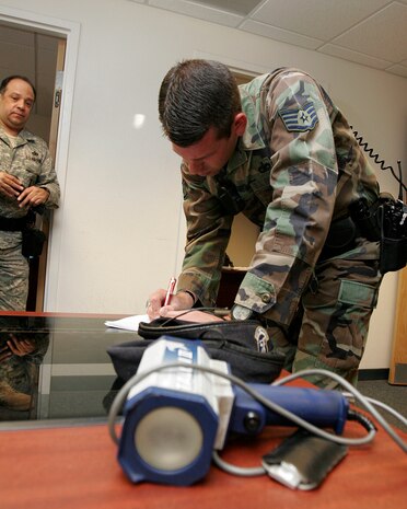 NELLIS AIR FORCE BASE, Nev.—Staff Sgt. Robert Eichenhorst, 99th Security Forces Squadron patrolman, completes paperwork after a traffic stop on base during his 12-hour shift here May 13. Documenting law enforcement activities upholds the integrity of the security forces mission and its Airmen. (U.S. Air Force photo/Staff Sgt. Jacob R. McCarthy)