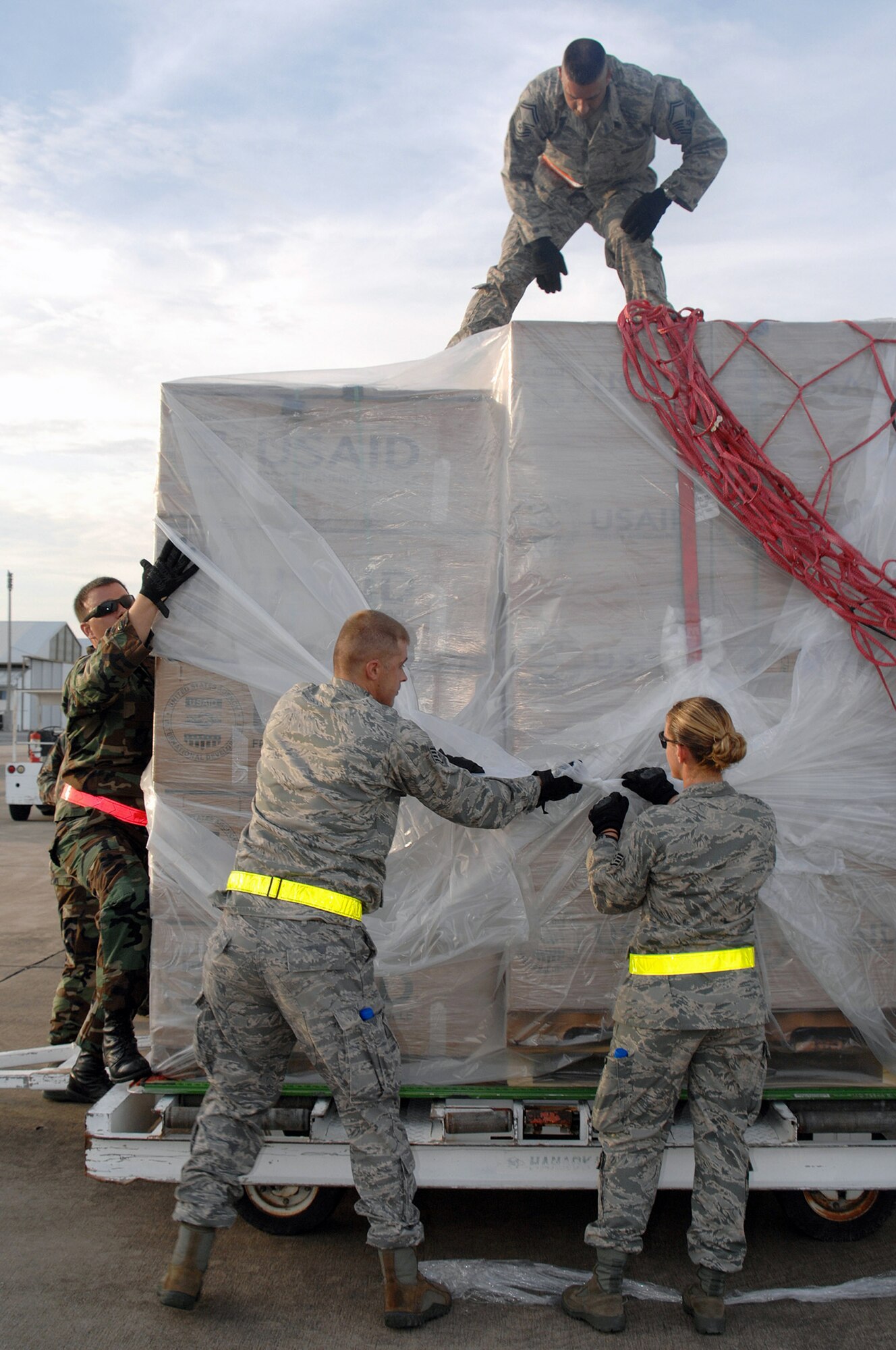 Airmen from Andersen Air Force Base, Guam, download humanitarian relief supplies from a Boeing 747 commercial airplane May 16 at Utapao Thai Royal Navy Air Base, Thailand, in preparation for delivery to Burma.  Approximately 45 Airmen with the 36th Contingency Response Squadron forward deployed to provide aid and recovery assistance after Cyclone Nargis struck May 2. (U.S. Air Force photo/Senior Airman Sonya Croston)