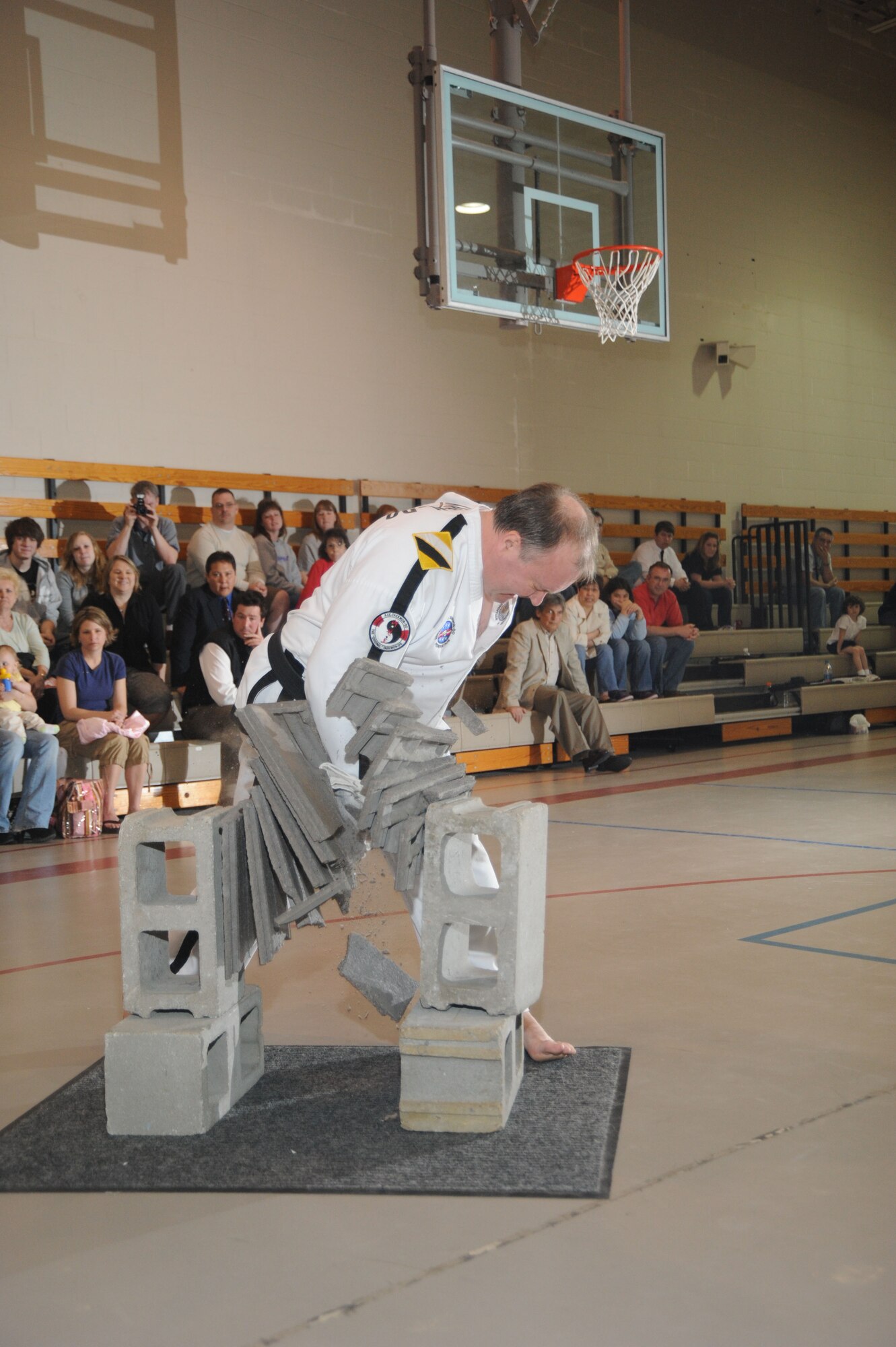 Ricky Todd, 6th degree black belt and head instructor for the U.S. TaeKwon-Do Federation's AXE TaeKwon-Do school in Bellevue, prepares to break through six cement tiles April 19 as part of the test for his 7th degree black belt master instructor status. (U.S. Air Force Photo By/ Dan Rohan)