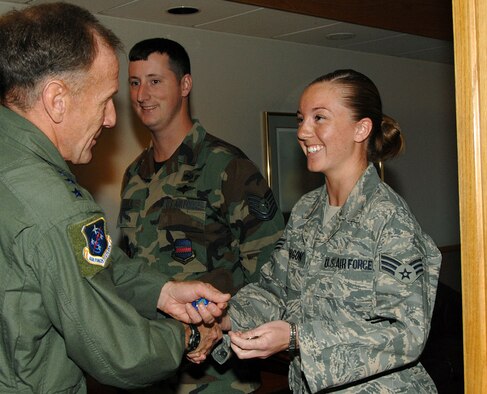 Lieutenant Gen. Norman Seip, 12th Air Force commander, presents coins to Senior Airman Christine Mirgon and Tech. Sgt. Chad Stoulil May 8 at the Base Operations building. General Seip took time out of his schedule following the annual Air Combat Command commander's conference here to offer his thanks to the 55th Operations Support Squadron, Airlift Validation Flight for their outstanding support. "The members of this flight are my hidden heroes," said Lt. Col. Mohan Krishna, 55th Operations Support Squadron director of operations. "They get senior leaders where they need to be, long time and within the rules. We really appreciated Lieutenant General Seip taking time from his busy schedule to personally thank these hard working Airmen." (Courtesy Photo)