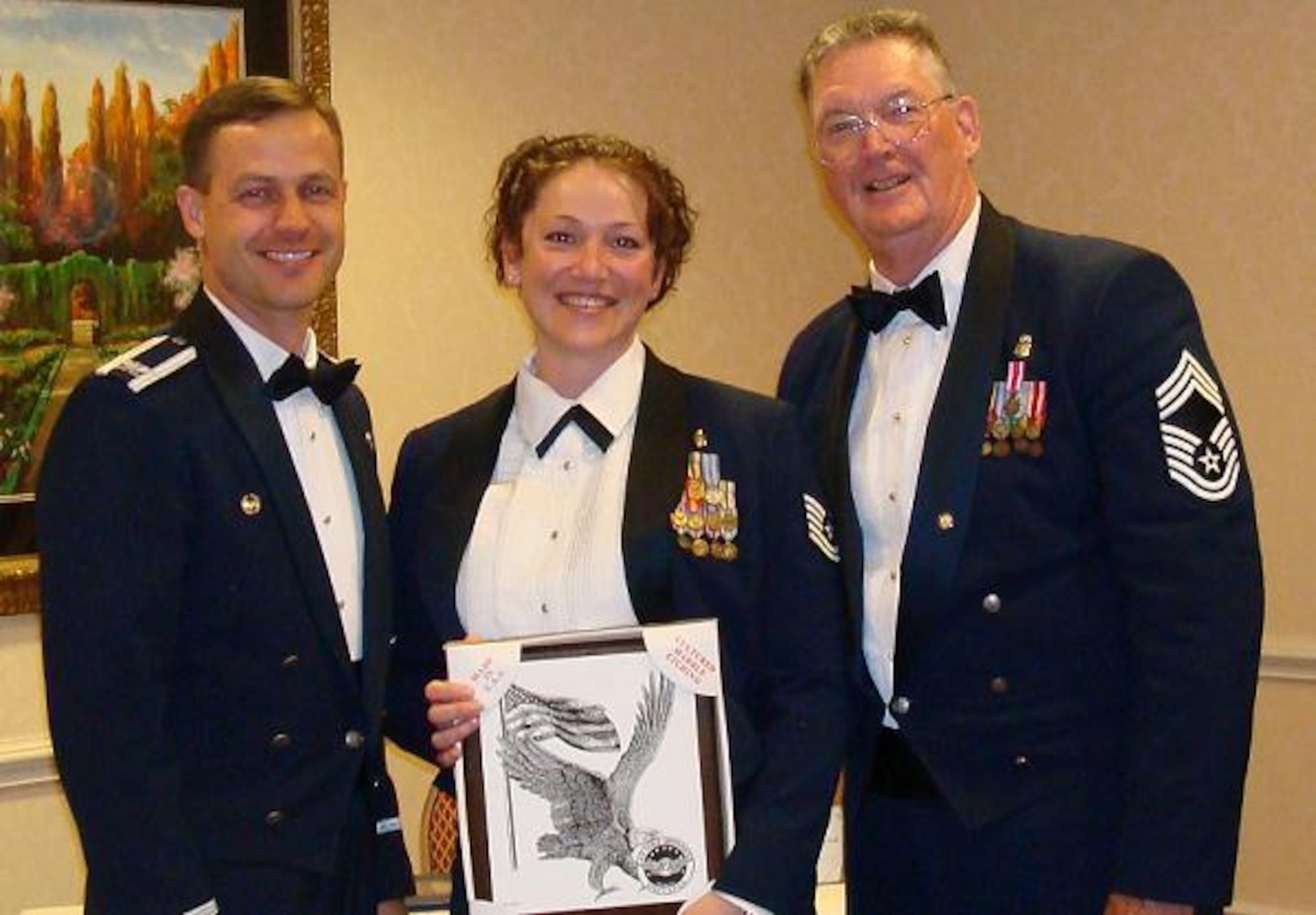Tech. Sgt. Tammy Roth, 305th Aeromedical Squadron, receives Divsion 2, 2007 NCO of the Year Award from Bill McMullen, Air Force Sergeants Association Division 2 President, and Col. Steven Harrison, 436th Airlift Wing commander