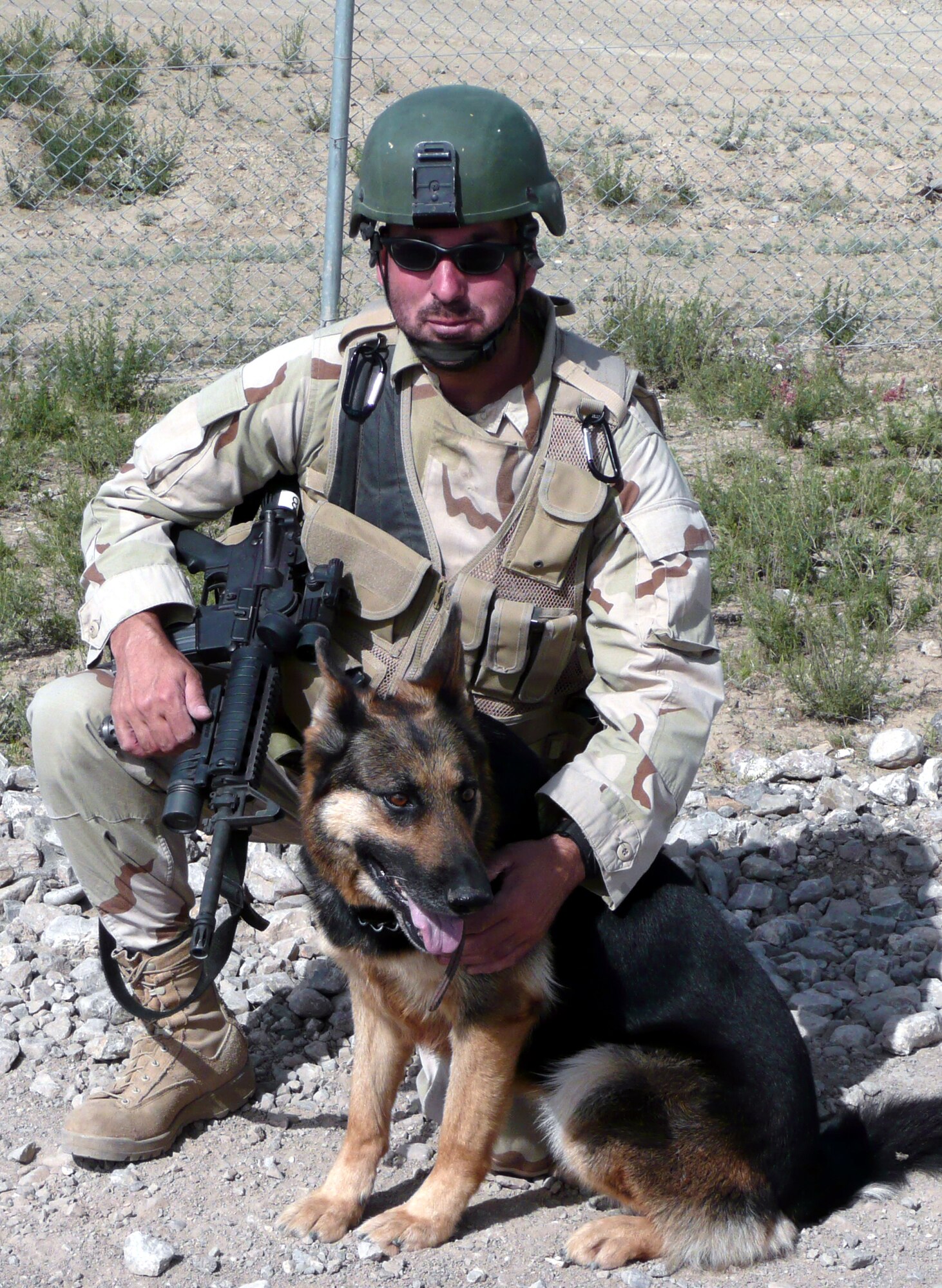 Staff Sgt. Christopher Dion and his military working dog Dena, both from the 6th Security Forces Squadron, MacDill Air Force Base, Fla., stop for a photo prior to leaving for a mission May 15, 2008, from Bagram Air Base, Afghanistan.  On his first deployment as an MWD handler, Sergeant Dion trained at home station and in the U.S. Air Force Expeditionary Center's Phoenix Warrior Training Course to get ready for to deploy.  In his words, Sergeant Dion says he's "excited to finally do what I've desired and trained to do for so long -- be an MWD handler."  (U.S. Air Force Photo)