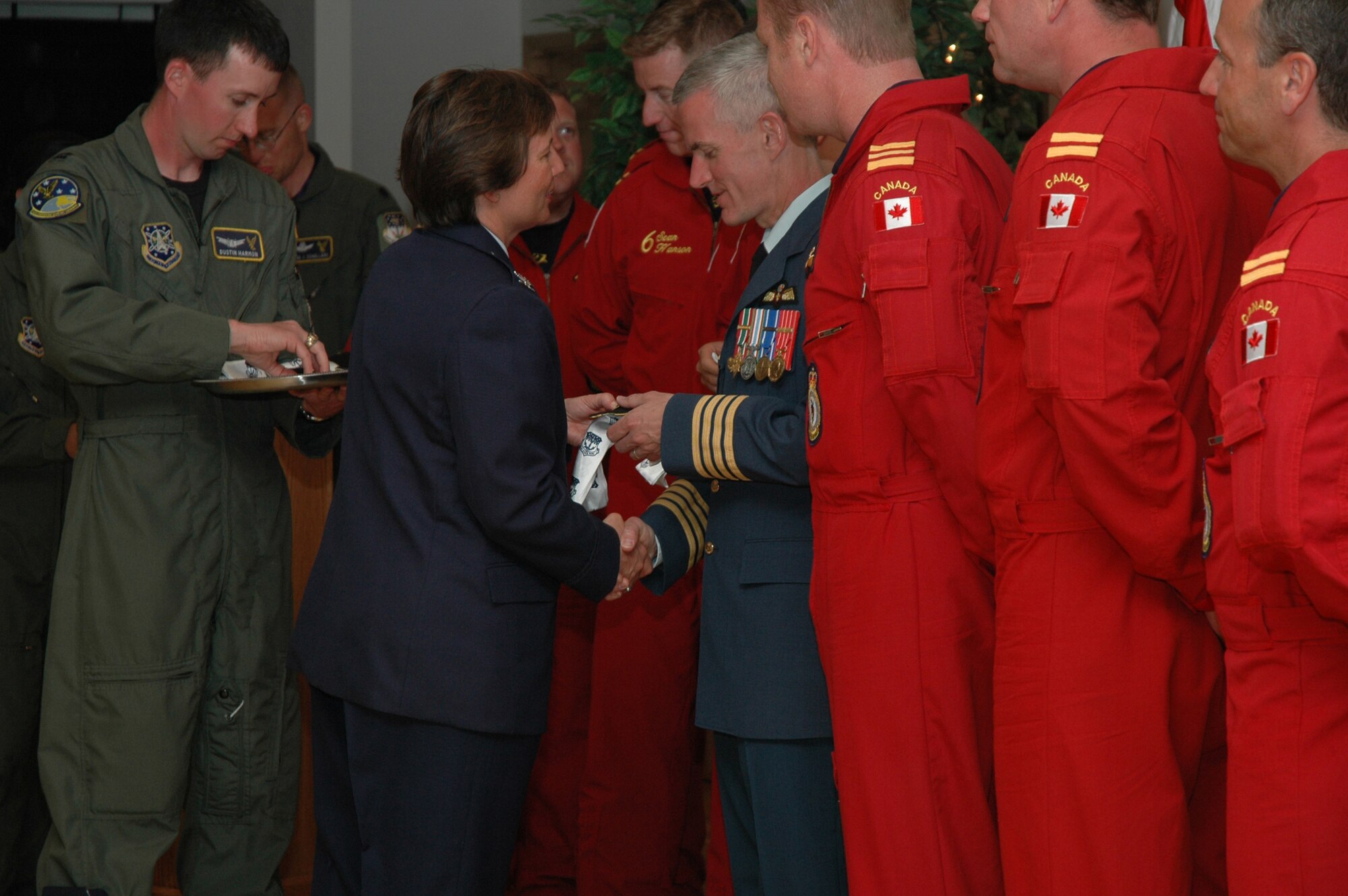 Col. Sandy Finan, 341st Space Wing commander, presents Col. Richard Foster, 15 Wing, Moose Jaw, Saskatchewan, commander, and the Canadian Forces Snowbirds aerial demonstration team, with Malmstrom scarves and patches. A social was held May 17 at the Grizzly Bend club to highlight the bond formed between Malmstrom and the Canadian Forces following last year's fatal crash of Snowbird 2, Capt. Shawn McCaughey. (U.S. Air Force photo/Airman 1st Class Emerald Ralston)