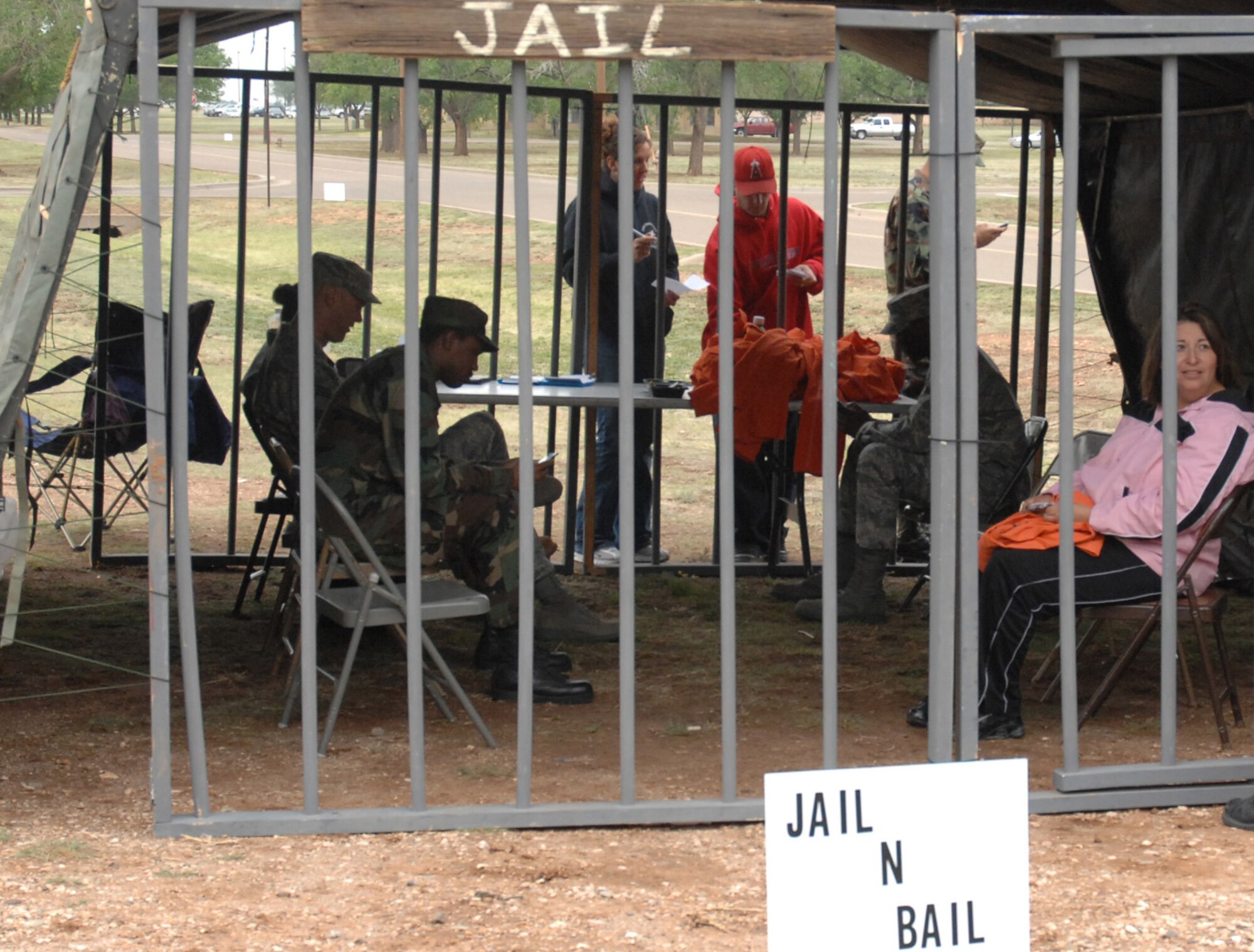 CANNON AIR FORCE BASE, N.M. - "Convicts" sit in jail after being "arrested" during the jail and bail at the Base Exchange May 15. The event was part of National Police Week, the week of May 15. (U.S. Air Force photo/Beth Merchant)