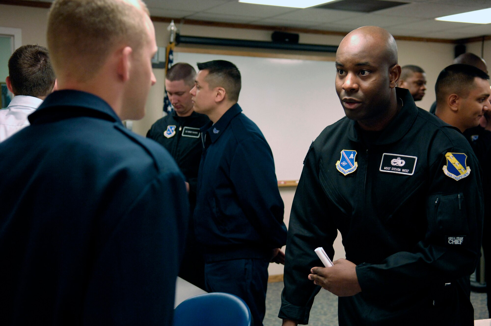 Drill team member Master Sgt. Steven West speaks with an Airman Leadership School student May 6 at Grand Forks Air Force Base, N.D., during an Air Force Honor Guard recruiting briefing. The drill team is the traveling component of the Air Force Honor Guard and tours world-wide representing all Airmen and showcasing Air Force precision to recruit, retain and inspire for the Air Force mission. (U.S. Air Force photo/Senior Airman Dan DeCook) 