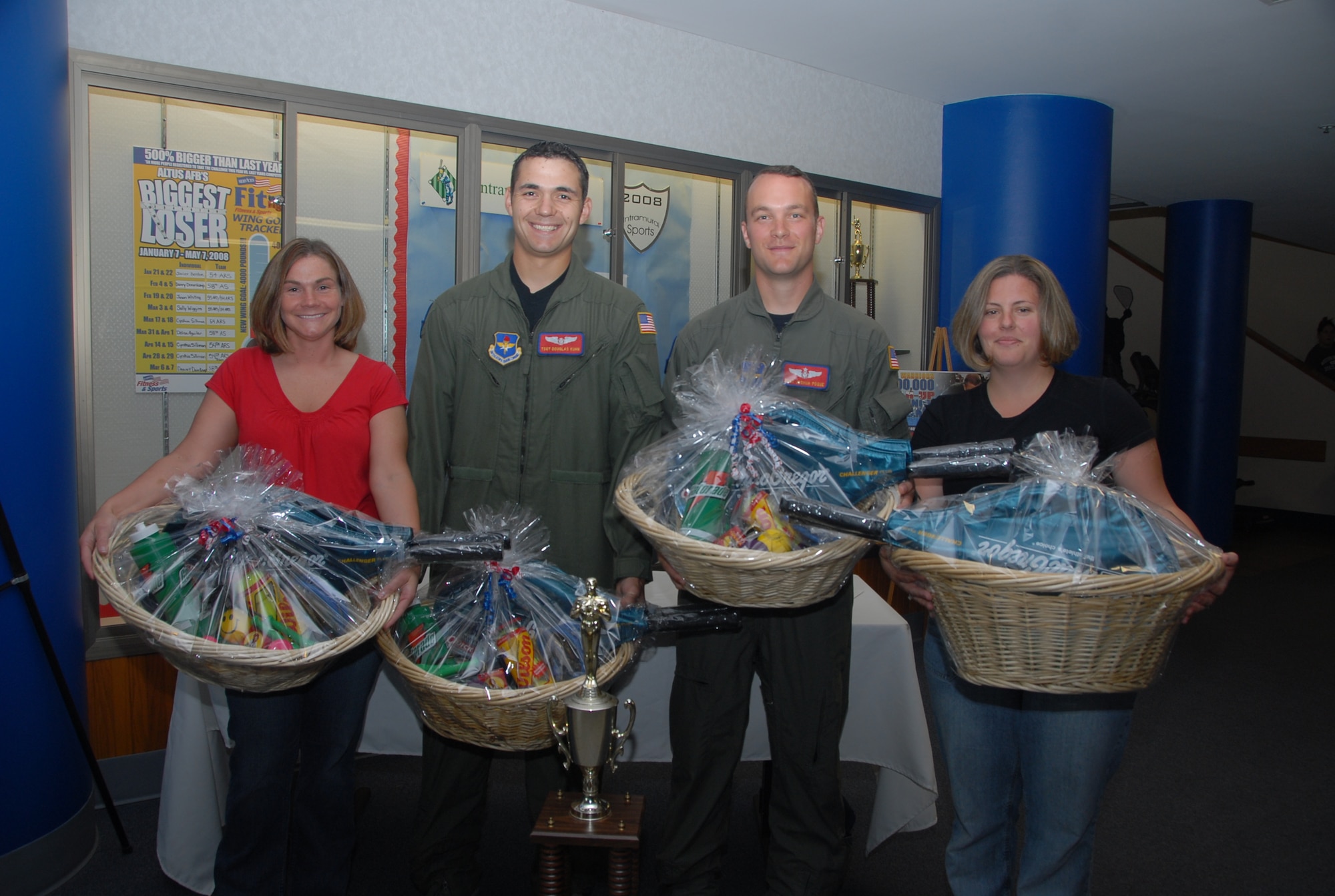ALTUS AIR FORCE BASE, Okla. -- From left, Staff. Sgt. Josh and Laura Pogue, and Tech. Sgt. Doug and Beth Kuhn of the 58th Airlift Squadron team took first place honors for "The Biggest Loser" program, which concluded recently at the Fitness and Sports Center. The 58 AS team lost a combined weight of 92.8 lbs. Top place finishers received prizes for their efforts. (U.S. Air Force photo/Airman 1st Class Cherice Bryant)