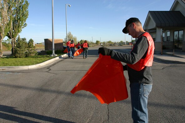 Col. Charles Mood, commander of the 419th Mission Support Group, unfurls a trash bag before setting out for the stretch of I-15 near Hill Air Force Base’s west gate to gather garbage. Colonel Mood, along with about 20 others volunteers from within the wing, rose early Saturday morning to support the semiannual 419th Top Three’s Highway Cleanup Project. By midmorning, the team had gathered 30 bags of trash that weighed in around 1,200 pounds. (U.S. Air Force photo/Bryan Magaña)