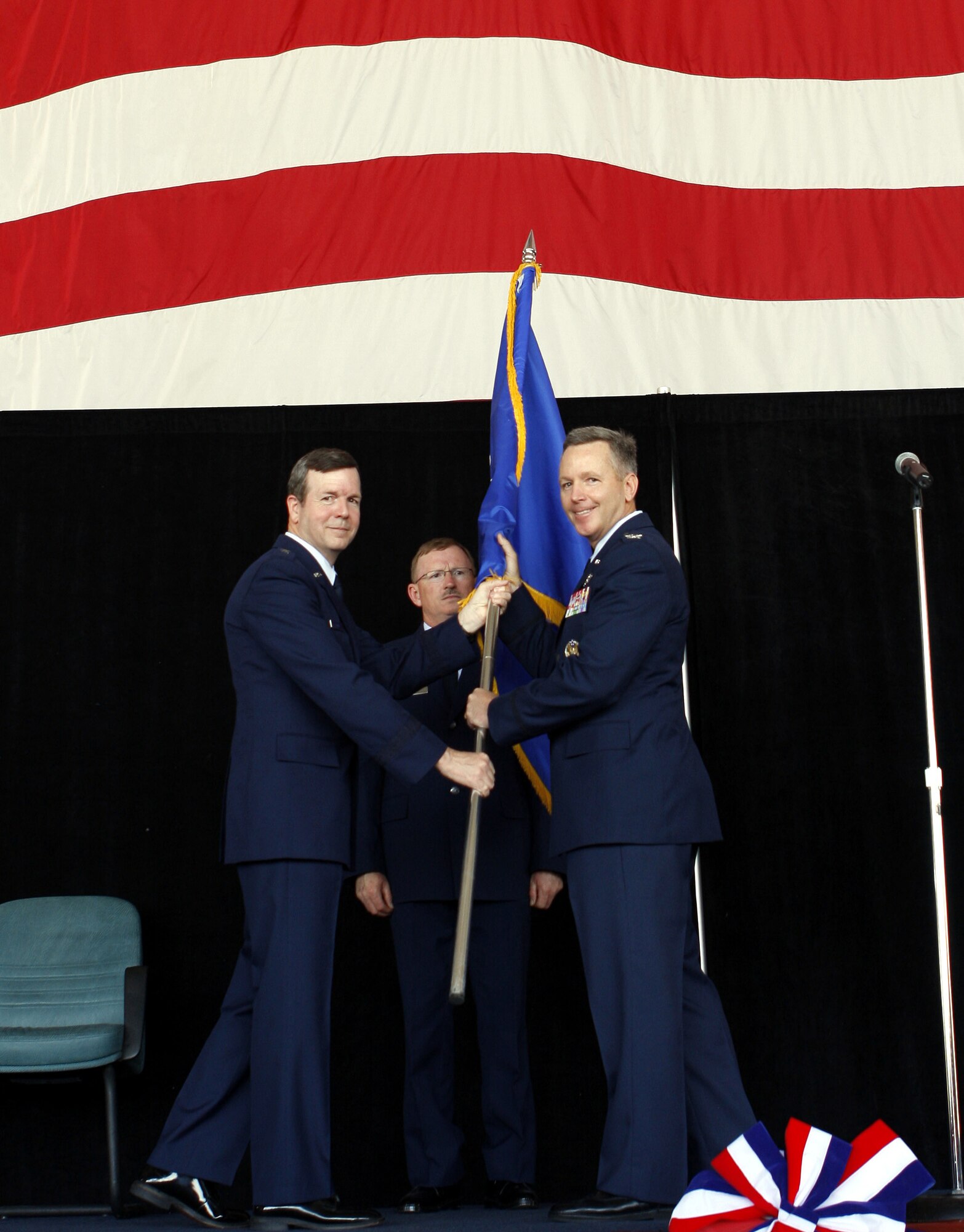 HOMESTEAD AIR RESERVE BASE, Fla. -- Col. William B. Binger (right) accepts the 482nd Fighter Wing guidon from Brig. Gen. Thomas Coon, 10th Air Force commander, during a change of command ceremony on May 18. Colonel Binger’s previous assignment was Deputy Director of Air Force Strategic Planning and Deputy Chief of Staff for Strategic Plans and Programs at Headquarters USAF. He is also a command pilot with more than 4,400 hours in the F-16, including 40 combat missions over Iraq. (Courtesy photo by Albert Siegel)