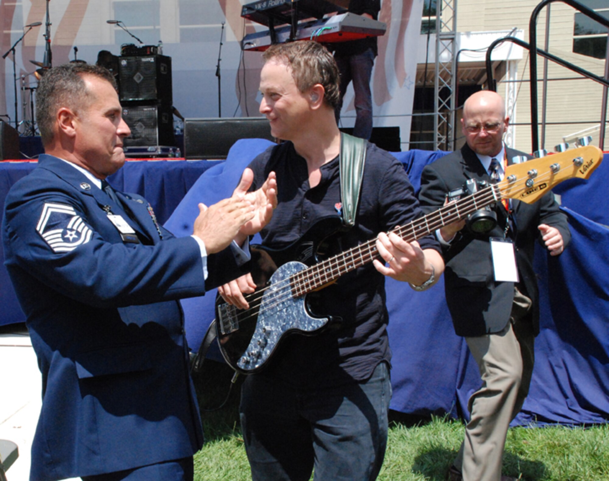 PATRICK AIR FORCE BASE, Fla. -- Senior Master Sgt. Rene Rubiella of the 920th Rescue Wing rocks out with actor and musician Gary Sinise at a special concert following the USA Freedom Corps President's Volunteer Service Awards ceremony.  Rubiella was one of seven military members honored at the White House for their community service.  After the ceremony, Gary Sinise and the "Lt. Dan Band" provided a special concert for the award recipients and their guests. (U.S. Air Force photo/Capt. Cathleen Snow)