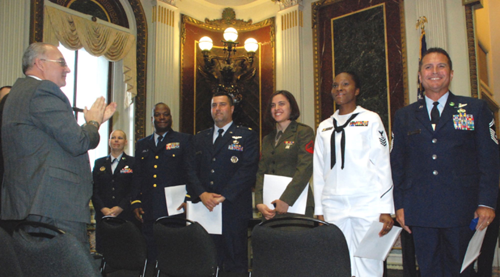 PATRICK AIR FORCE BASE, Fla. -- Senior Master Sgt. Rene Rubiella (right), along with other USA Freedom Corps Volunteer Service Award winners, receives a standing ovation during a special ceremony at the White House on May 16.  Rubiella, who is the 920th Operations Group superintendent, has volunteered his time for a number of programs to benefit the community including Habitat for Humanity, Melbourne Daily Bread Soup Kitchen and Operation Not on Our Watch.  (U.S. Air Force photo/Capt. Cathleen Snow) 