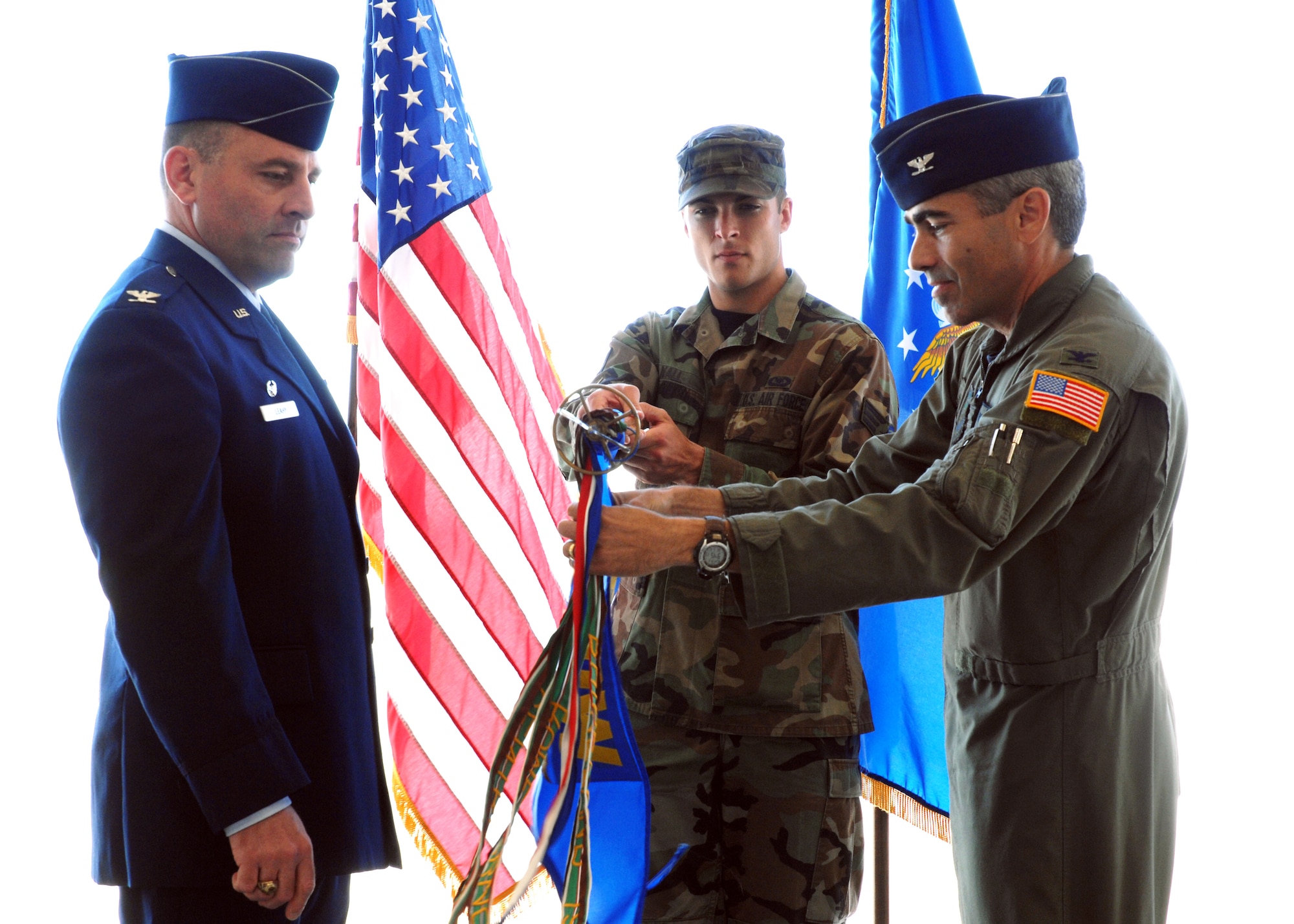 CANNON AIR FORCE BASE, N.M.-- Col. Valentino Bagnani III (right), 27th Special Operations Wing vice commander, unfurls the 318th Special Operations Squadron colors as Col. Timothy Leahy, 27th SOW commander, looks on during activation ceremonies May 16. Colonel Bagnani unfurled the colors in honor of his father, a former commander of the 318th SOS. (U.S. Air Force photo/Airman 1st Class Danielle Martin)