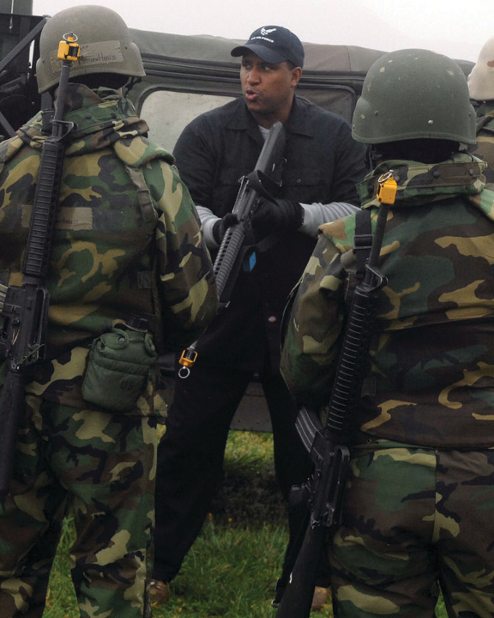 LANGLEY AIR FORCE BASE, Va. -- Mr. William Rupert, 1st Security Forces Squadron expeditionary combat skills instructor, explains to Airmen how to work as partners, taking tactical deployment positions while exiting a Humvee here April 10. Combat Skills Training is a basic three-day course for deploying personnel where Airmen who are normally in noncombatant roles learn to shoot, move and communicate. (U.S. Air Force photo/Master Sgt.Carlos J. Claudio)