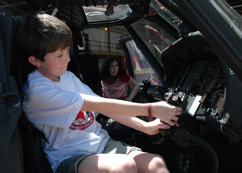 BUCKLEY AIR FORCE BASE, Colo. -- Michael Lynch, son of Lt. Col. Allison Lynch, Air Reserve Personnel Center, sits in a UH-60 Blackhawk during Buckley's Military Family Appreciation Day, May 17, at Hangar 909. The Blackhawk was on static display, from the Colorado National Guard, at the event. (U.S. Air Force photo by Staff Sgt. Sanjay Allen)