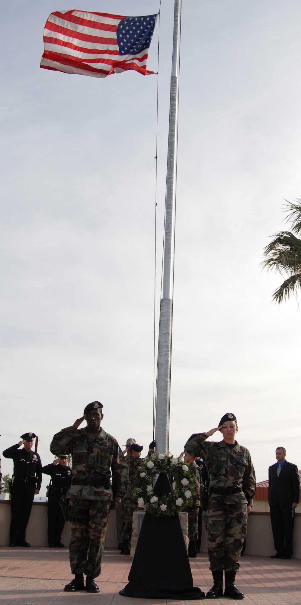 Members of the 95th Security Forces Squadron salute the American flag during a Peace Officer Ceremony in front of the Air Force Flight Test Center here May 15. The Peace Officer Ceremony is dedicated to military and civilian police offers who have died in the line of duty. (Air Force photo by Senior Airman Stacy Sanchez)