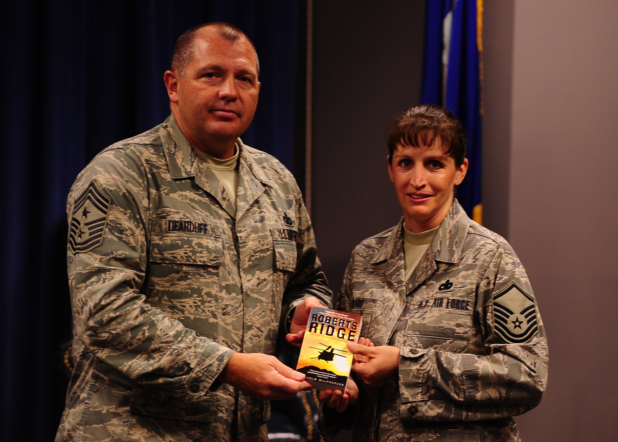 MOODY AIR FORCE BASE, Ga. -- 9th Air Force Command Chief Master Sgt. Scott H. Dearduff presents a book to Master Sgt. Tiffany Berard, commandant of the Jason D. Cunningham Airman Leadership School here May 13. In addition to ALS, Chief Dearduff also visited the 723rd Aircraft Maintenance Squadron, 93rd Air Ground Operations Wing and the 820th Security Forces Group. (U.S. Air Force photo by Senior Airman Elizabeth Rissmiller)
