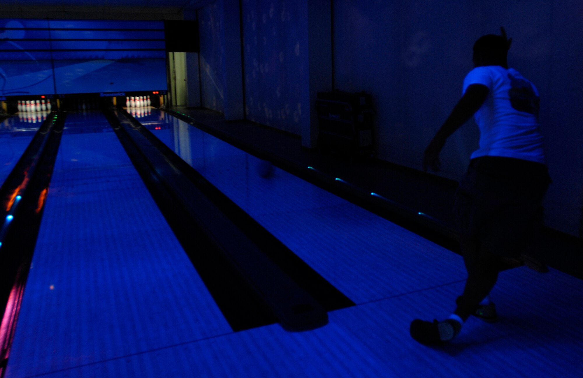 AVIANO AIR BASE, Italy --  Douglas Cox shows perfect form as he spins the bowling ball down the lane May 17.  Reservations for cosmic bowling can be made by calling 632-7487.  (U.S. Air Force photo/Airman 1st Class Ashley Wood)   