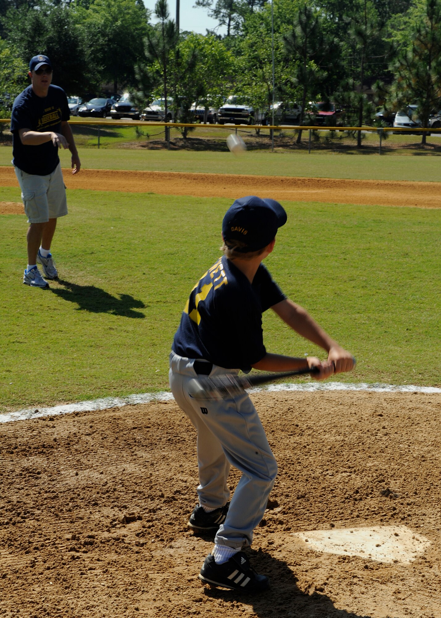 VALDOSTA, Ga. -- Staff Sgt. Kelby Cox, 71st Rescue Squadron flight engineer and baseball coach, pitches a ball to Davis Hewett, son of Master Sgt. Mark Hewitt, 71st RQS flight engineer, during a pre-game warm up at Valdosta, Ga., May 17. The 71st RQS sponsors The Kings, a baseball team of six and seven-year-olds in the local community. (U.S. Air Force photo by Airman 1st Class Brittany Barker)