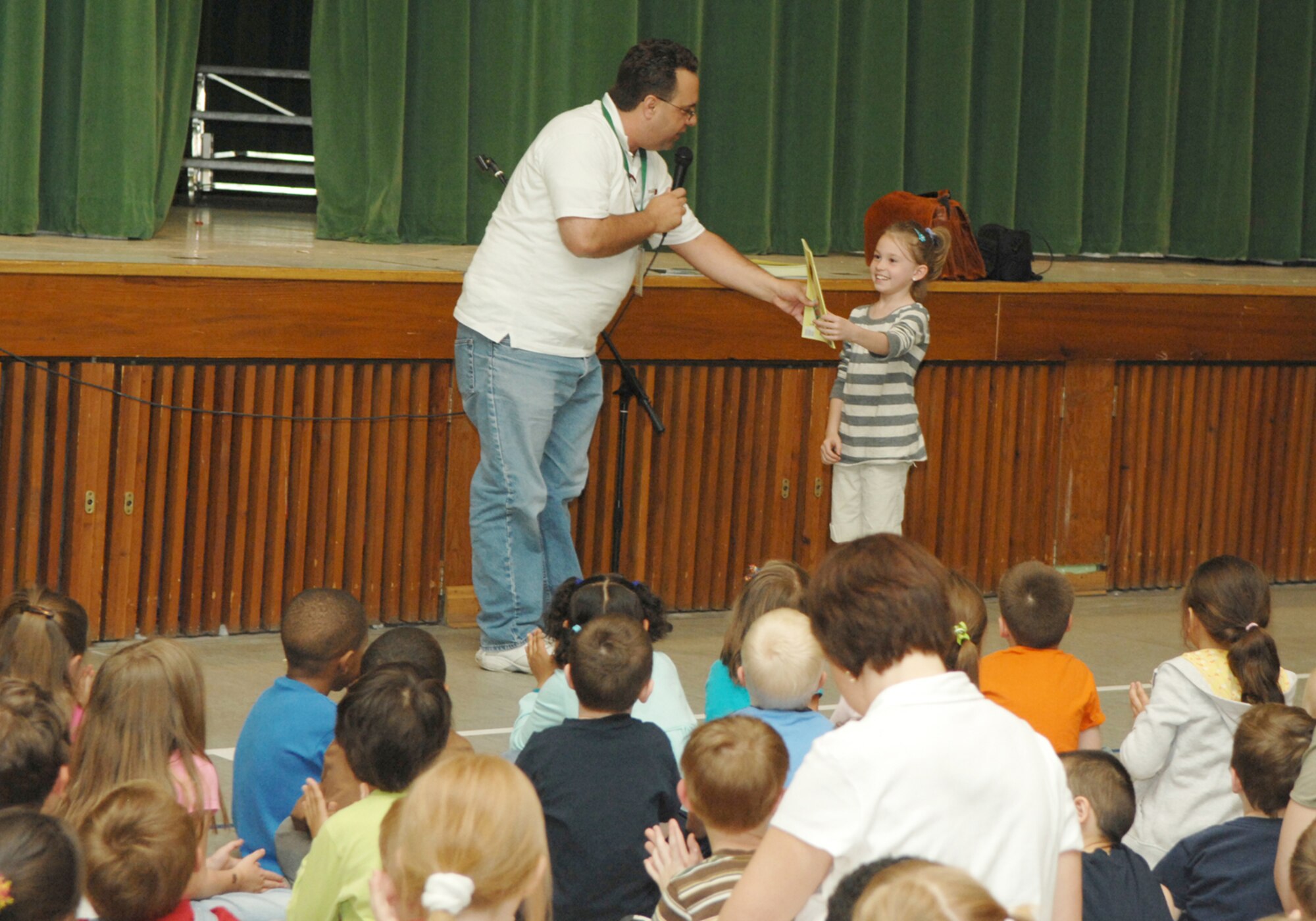 SPANGDAHLEM AB, Germany - Sam Renick, author of the book, “It's A Habit, Sammy Rabbit!” visits Spangdahlem Elementary School May 12, 2008, to teach children how to be financially responsible. Mr. Renick sang songs, told stories and discussed the importance of saving money.  Allison Penton received an autographed copy of the short story for participating in a contest where students guessed the name of the chapters after reading them.
U.S. Air Force photo by Staff Sgt. Heather M. Norris