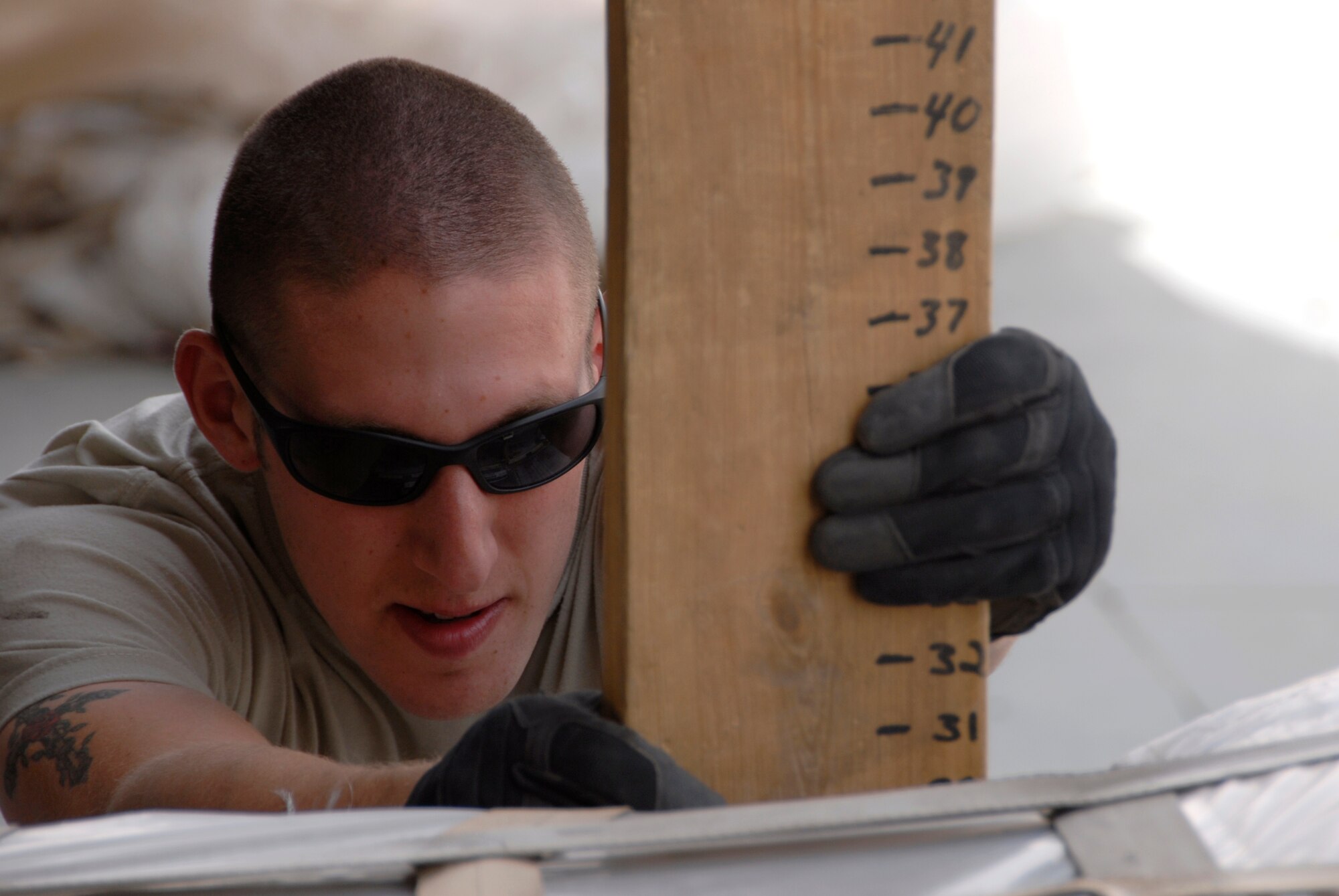 SOUTHWEST ASIA -- Airman 1st Class Jonathan Weaver, a cargo processor deployed to the 386th Expeditionary Logistics Readiness Squadron's aerial port flight, checks the height of a pallet May 15, 2008, at an air base in the Persian Gulf Region. The aerial port flight handles all loading and unloading of military and coalition partners' aircraft departing and arriving the base and is responsible for processing all originating, through load, and terminating cargo. This flight is U.S. Central Command's largest passenger operation, handling over 65,000 passengers a month in support of Operations Enduring and Iraqi Freedom. Airman Weaver is deployed from the 60th Aerial Port Squadron, Travis Air Force Base, Calif. (U.S. Air Force photo/ Staff Sgt. Patrick Dixon)