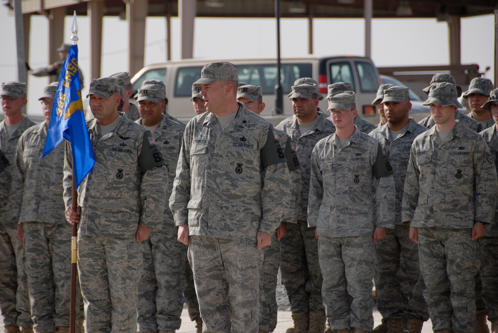 SOUTHWEST ASIA -- Lieutenant Col. Martin Rothrock, 386th Expeditionary Security Forces Squadron Commander, issues the command 'Present Arms' to the formation in an expedited retreat ceremony during National Police Week May 16, 2008, at an air base in the Persian Gulf Region. Airmen 'Defenders' from the 386th ESFS commemorated National Police Week, May 11-17, hosting a series of events to celebrate the memory of their fallen comrades. (U.S. Air Force photo/ Staff Sgt. Patrick Dixon)
