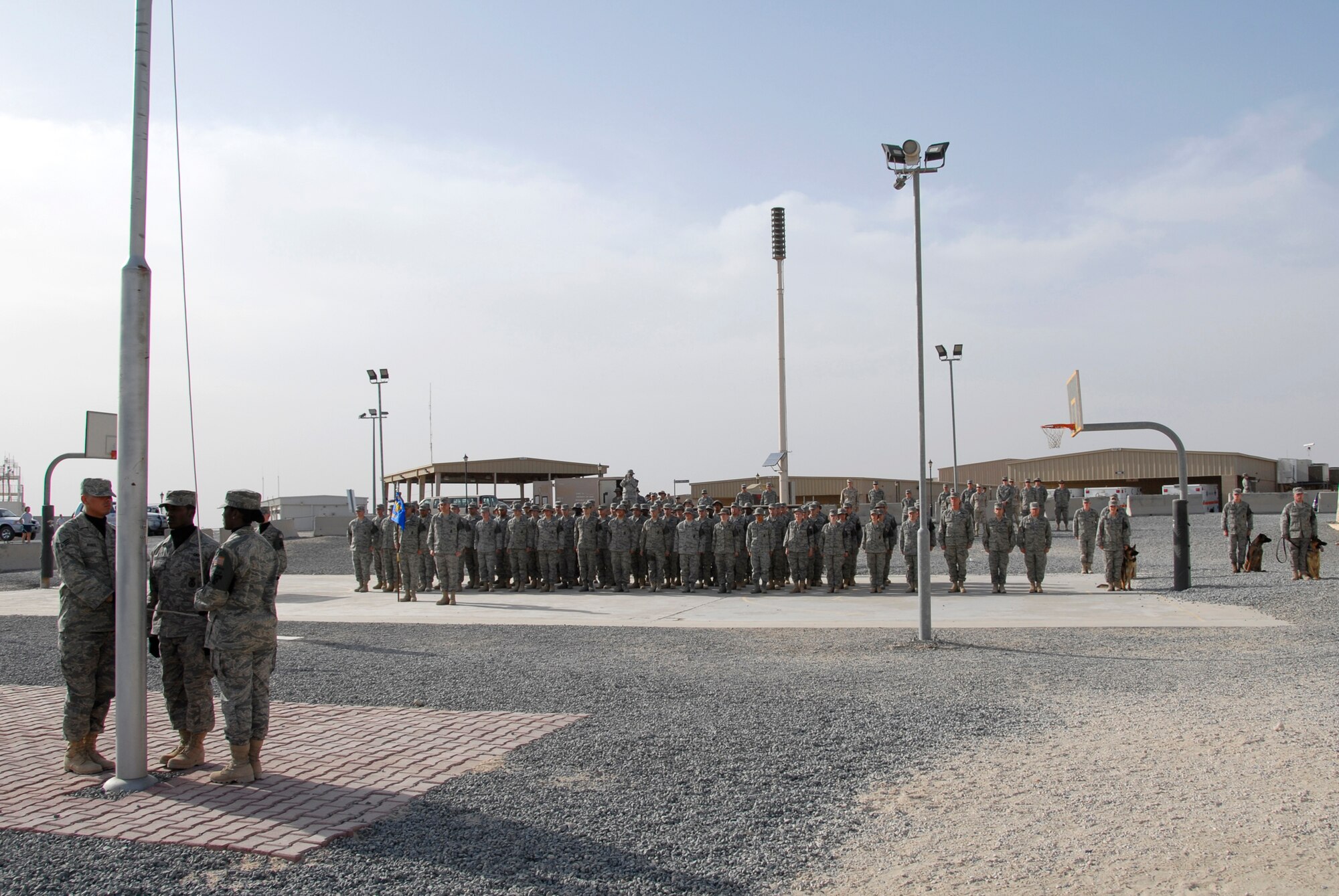 SOUTHWEST ASIA -- Airmen 'Defenders' from the 386th Expeditionary Security Forces Squadron stand at attention in an expedited retreat ceremony during National Police Week May 16, 2008, at an air base in the Persian Gulf Region. The 386th ESFS commemorated National Police Week, May 11-17, hosting a series of events to celebrate the memory of their fallen comrades. (U.S. Air Force photo/ Staff Sgt. Patrick Dixon)