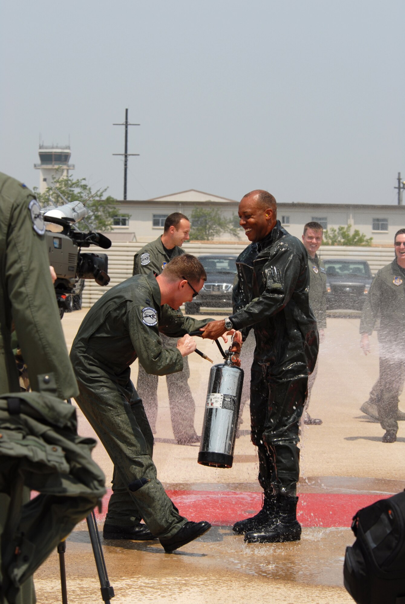 KUNSAN AIR BASE, Republic of Korea --  Colonel CQ "Wolf" Brown, 8th Fighter Wing commander, is welcomed back from his fini-flight with fire hoses here May 19. The fini-flight is a time-honored military aviation tradition marking the end of pilots or commander's time, upon completion of their final flight. (U.S. Air Force Photo/Senior Airman Angela Ruiz)