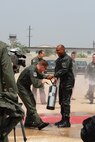KUNSAN AIR BASE, Republic of Korea --  Colonel CQ "Wolf" Brown, 8th Fighter Wing commander, is welcomed back from his fini-flight with fire hoses here May 19. The fini-flight is a time-honored military aviation tradition marking the end of pilots or commander's time, upon completion of their final flight. (U.S. Air Force Photo/Senior Airman Angela Ruiz)