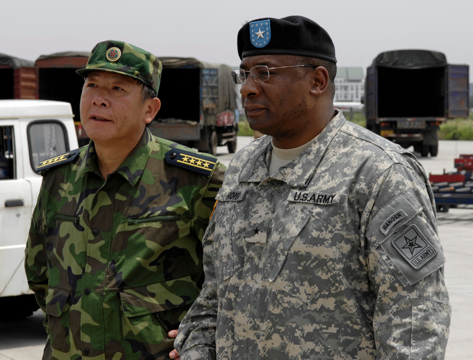CHENGDU SHUANGLIU INTERNATIONAL AIRPORT, People’s Republic of China (May 18, 2008) – US Army Brigadier General Charles W. Hopper, U.S. Defense Attache, and Senior Captain GUAN Youfei, Deputy Director for the Chinese Ministry of Defense's Foreign Affairs Office, watch a C-17 Globemaster III from Hickam Air Force Base, Hawaii unload relief supplies at Chengdu Shuangliu International Airport in China. The United States Pacific Command support of earthquake relief efforts was authorized by Secretary of Defense Robert Gates, in support of the U.S. Department of State. (US Air Force photo / Tech. Sgt. Chris Vadnais)