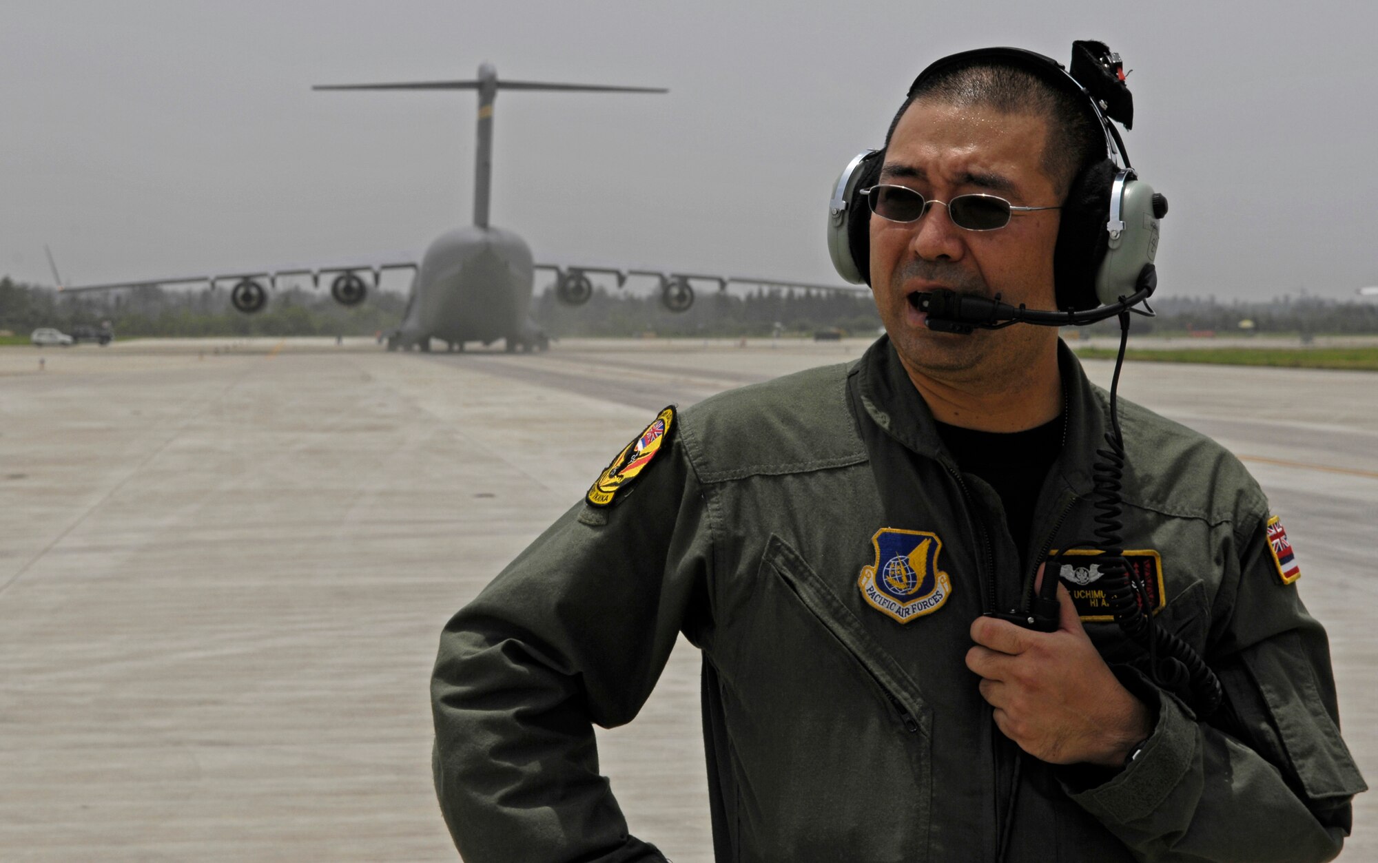 CHENGDU SHUANGLIU INTERNATIONAL AIRPORT, People’s Republic of China (May 18, 2008) – Master Sgt. Kurt Uchimura, a C-17 loadmaster assigned to the Hawaii Air National Guard's 204th Airlift Squadron, ensures the runway is clear for takeoff after unloading nearly 100,000 pounds of cargo at Chengdu Shuangliu International Airport in China. Master Sgt. Uchimura was on the first of the two jets to arrive in China; the second is taxiing in behind him. The United States Pacific Command support of earthquake relief efforts was authorized by Secretary of Defense Robert Gates, in support of the U.S. Department of State. (US Air Force photo / Tech. Sgt. Chris Vadnais)