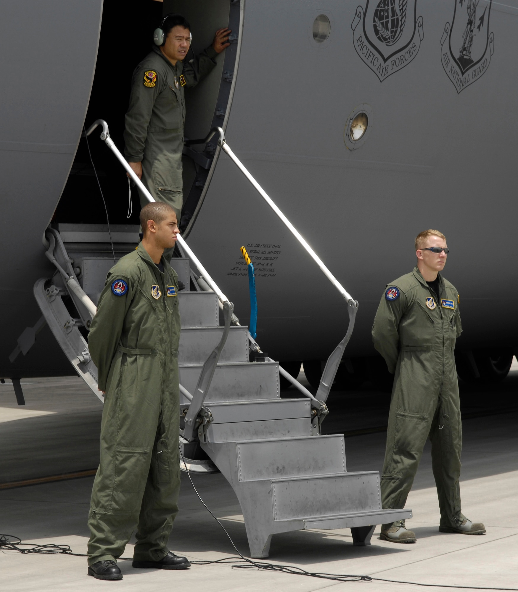 CHENGDU SHUANGLIU INTERNATIONAL AIRPORT, People’s Republic of China (May 18, 2008) – Staff Sgt. Scott Oshiro, a C-17 loadmaster with the Hawaii Air National Guard's 204th Airlift Squadron, prepares to depart Chengdu Shuangliu International Airport in China after delivering nearly 100,000 pounds of relief supplies, while Senior Airman Anthony Nickel and Senior Airman Ronald Peoples  with the 15th Security Forces Squadron, post security for the aircraft. The United States Pacific Command support of earthquake relief efforts was authorized by Secretary of Defense Robert Gates, in support of the U.S. Department of State. (US Air Force photo / Tech. Sgt. Chris Vadnais)