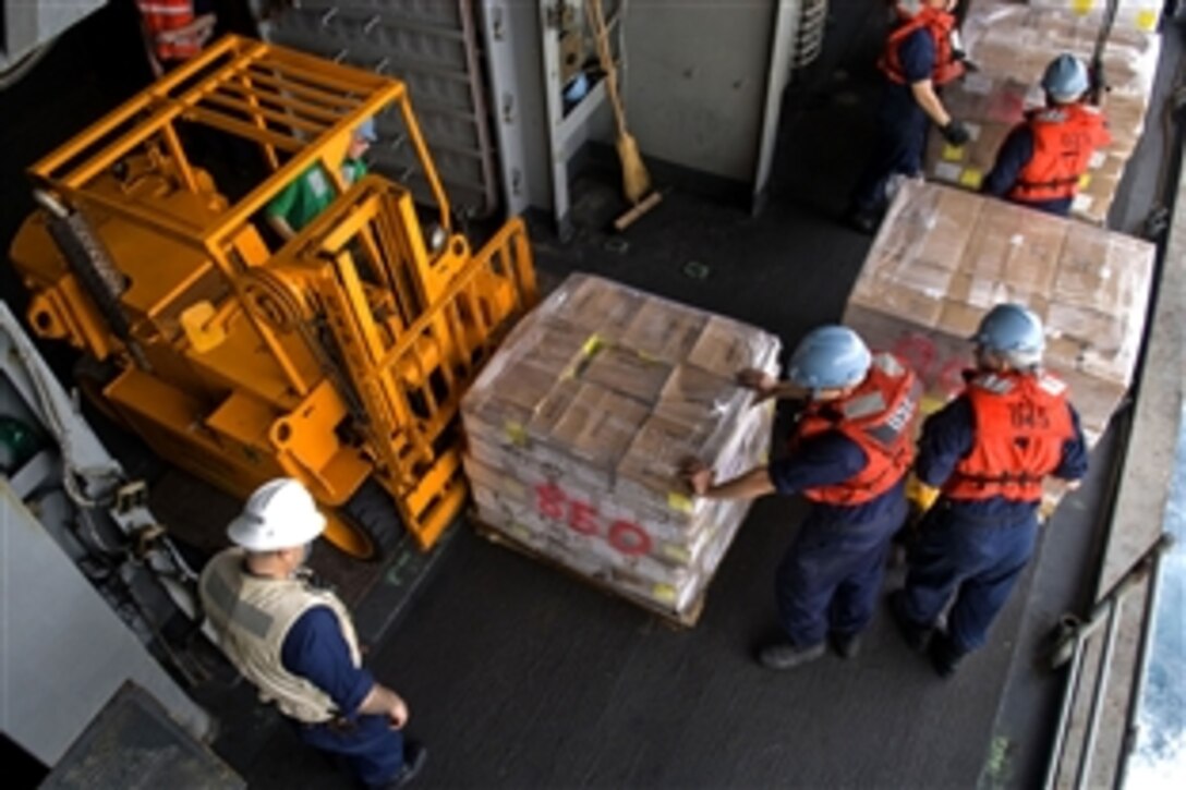 U.S. sailors move pallets of supplies into the hangar bay of the amphibious assault ship USS Essex during a replenishment at sea with the fleet replenishment oiler USNS Walter S. Diehl while under way in the Andaman Sea, May 17, 2008. The Essex Expeditionary Strike Group is preparing to support a humanitarian assistance tasking in Burma in the wake of Tropical Cyclone Nargis.