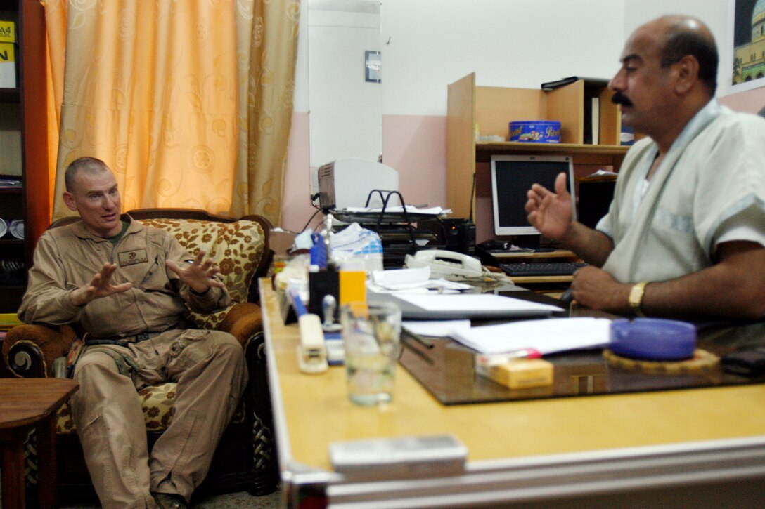 Capt. Benjamin D. Sanders (left), company commander, Company K, 3rd Battalion, 6th Marine Regiment, Regimental Combat Team-1, and Iraqi Police Maj. Rashid Hamid Calih Mobarak al-Ajely discuss future plans to improve the Jolan district in Fallujah, May 19. Officials are shifting their focus on improving local schools, public works and tearing down destroyed buildings in the area. (Official U.S. Marine Corps photo by Cpl. Chris Lyttle) (RELEASED)
