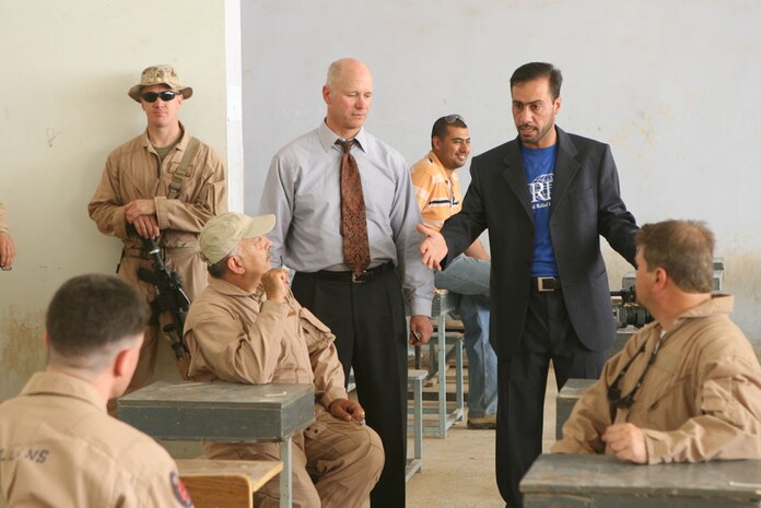 Samir Miflih Hamid, a local program manager in Haditha, Iraq, speaks with members of the Embedded Provincial Reconstruction Team and US Agency for International Development in a newly refurbished technical school Monday. The ePRT and USAID members have funded more than $2 million in projects since February in efforts to rebuild Iraq. The technical school will offer machinery and mechanical classes to both men and women once completed.