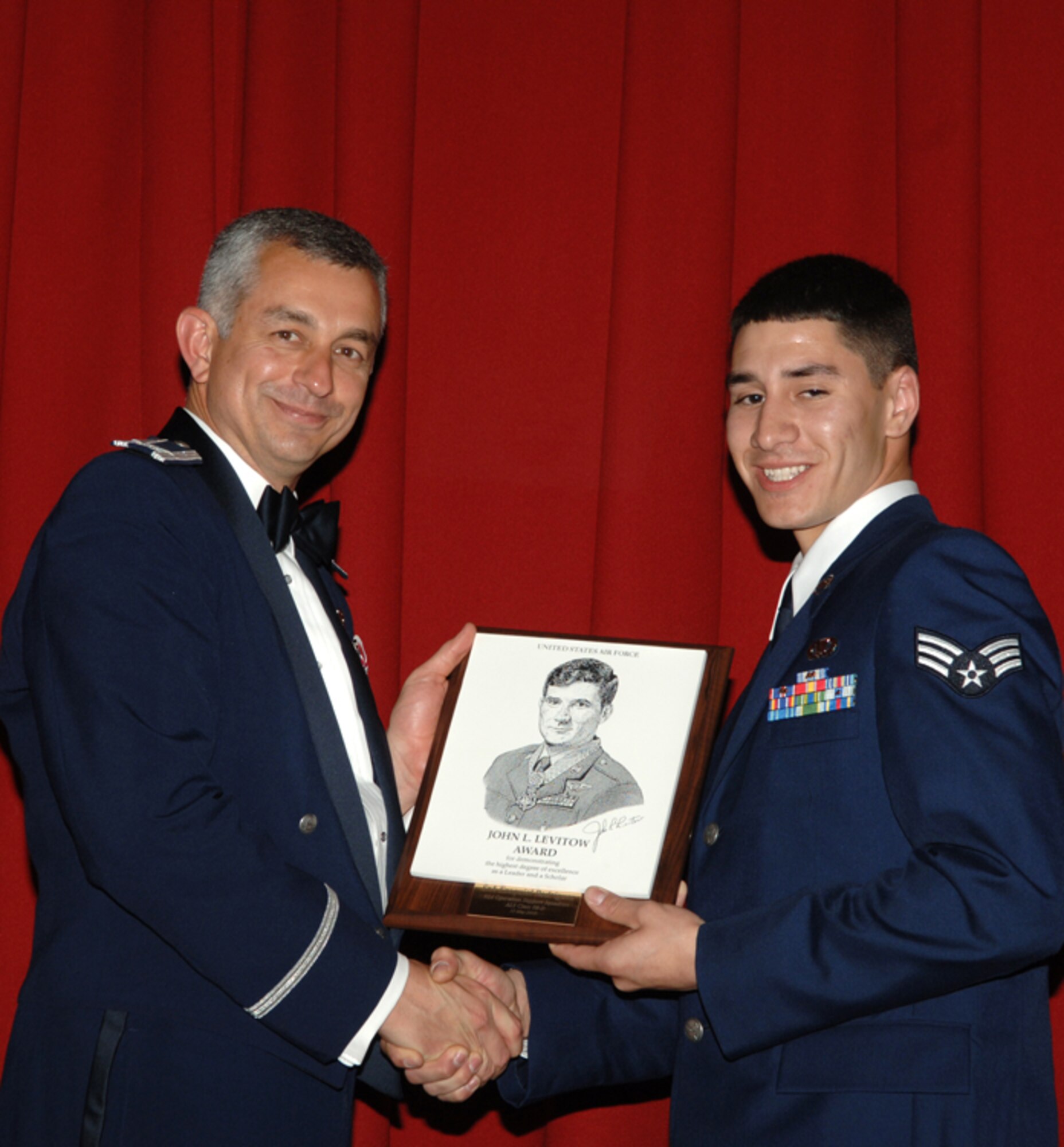 FAIRCHILD AIR FORCE BASE, Wash. – Col. Roger Watkins, 92nd Air Refueling Wing vice commander, presents a John Levitow Award to Senior Airman Ezequiel Rodriguez of the 92nd Operations Support Squadron. The prestigious Levitow award is the highest Professional Military Education award given in enlisted PME classes, indicating excellence in academics, leadership and peer standing. (U.S. Air Force photo / Senior Airman Jocelyn Ford)